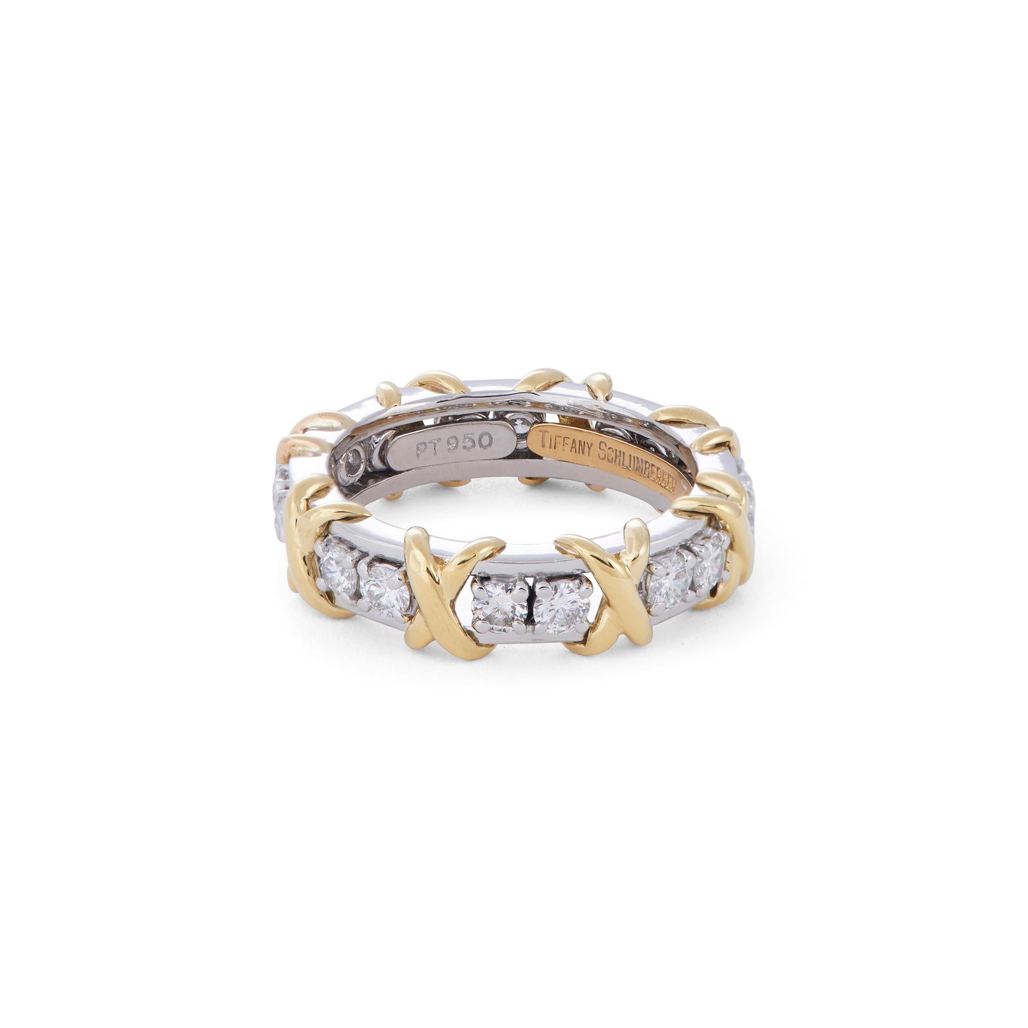 Authentic Jean Schlumberger for Tiffany & Co. ring crafted in platinum comprised of alternating 18 karat yellow gold X's and sixteen sparkling round brilliant cut diamonds weighing an estimated 1.14 carats (G-H, VS). Signed Tiffany, Schlumberger,