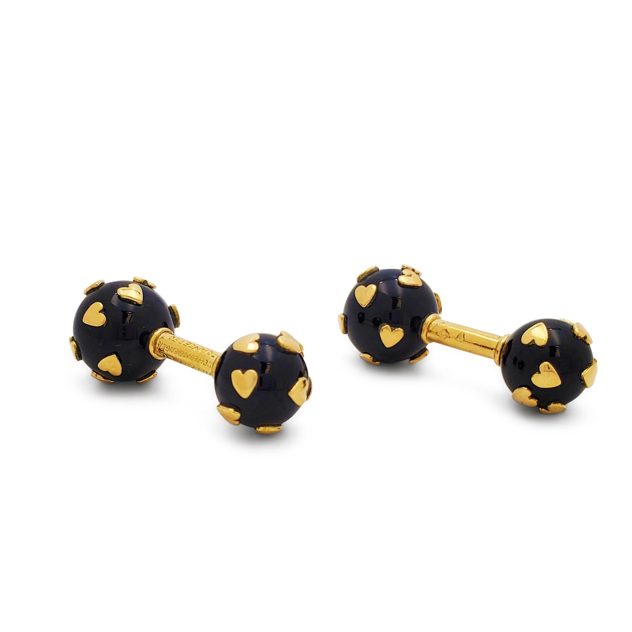A charming pair of barbell cufflinks designed by Jean Schlumberger for Tiffany & Co.  Each cufflink end features an onyx sphere dotted with yellow gold hearts.  The larger end of each cufflink measures .48 inches wide, the smaller end measures .40