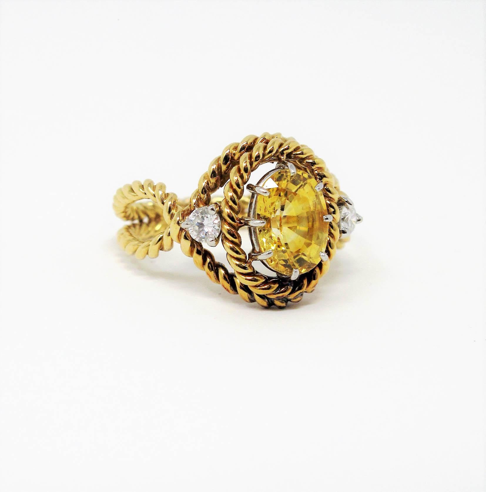 Stunning limited edition yellow sapphire and diamond ring designed by Jean Schlumberger for Tiffany & Co. This unique piece features a brilliant yellow oval mixed cut sapphire stone set among an artfully arranged twisted cable design in 18 karat