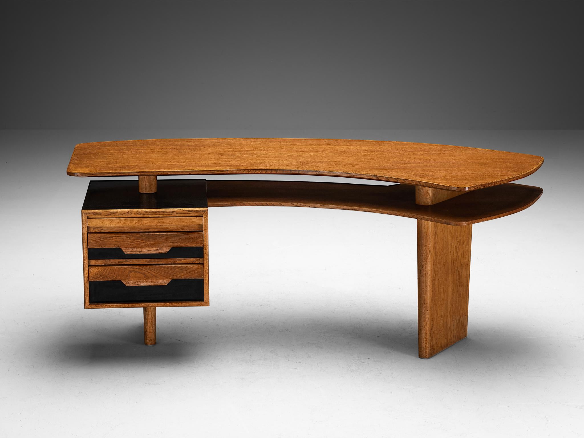 Jean Souvrain desk, oak, black melamine, France, ca 1955

Stunning asymmetrical desk designed by Jean Souvrain around 1955. This desk is a monumental piece of furniture with an amazing design and detailing. Made in oak with black melamine details,
