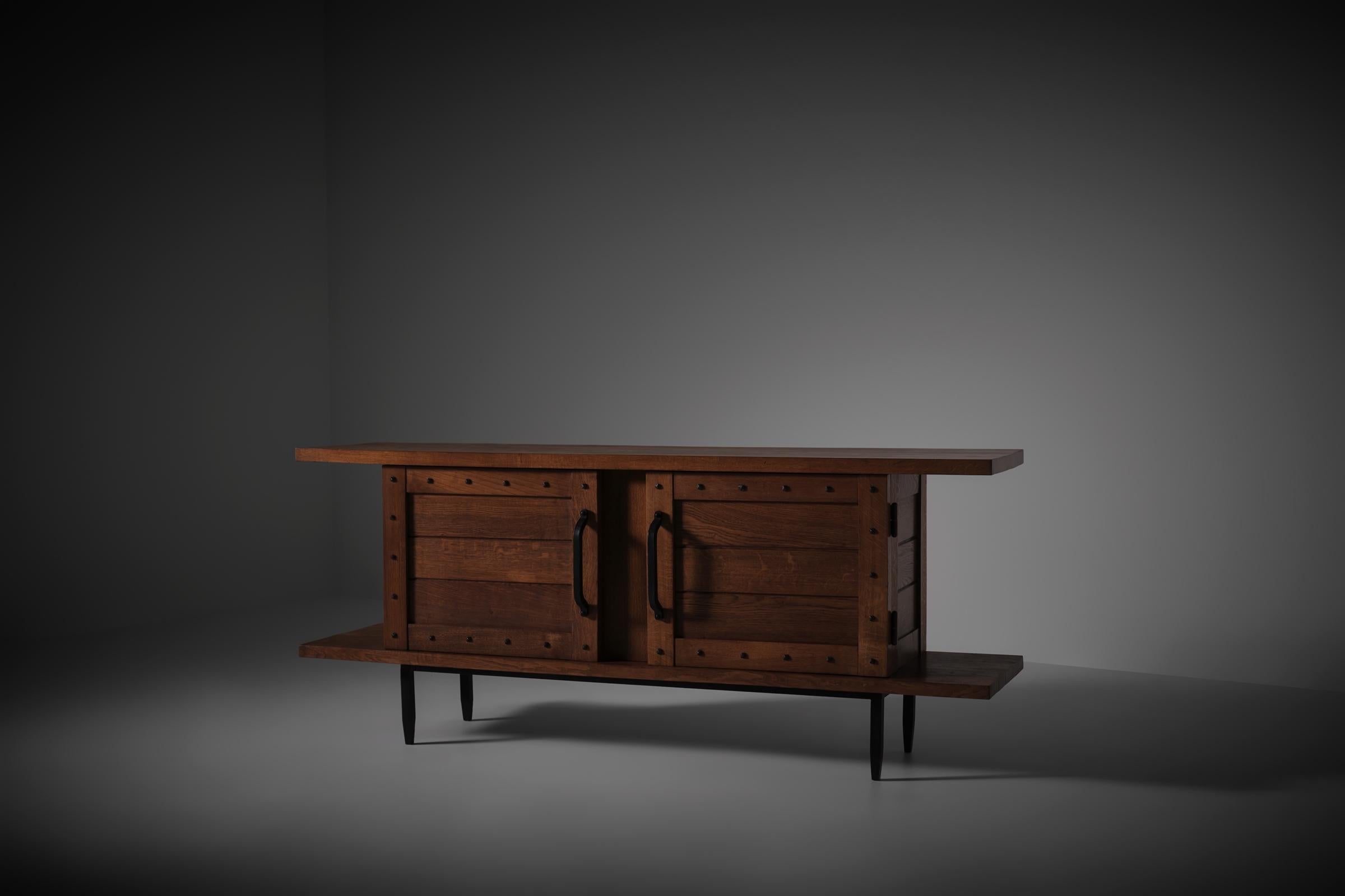 Rare sideboard in solid Oak and wrought Iron by Jean Touret & Les Artisans de Marolles, France 1950s. Clean and modest lines made from raw and honest materials such as solid French Oak and wrought iron, showcasing the philosophy of Jean Touret.
