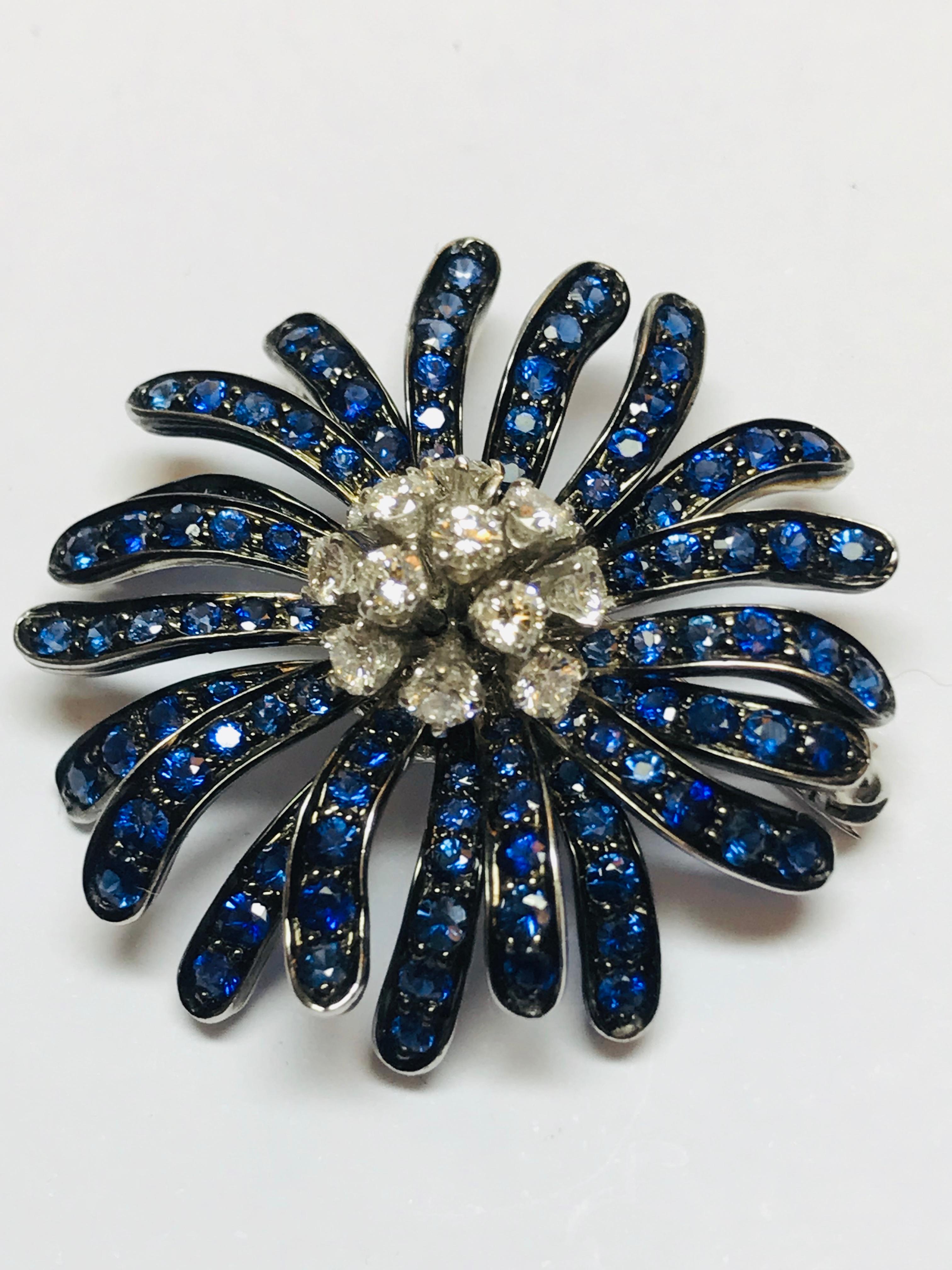 This beautifully designed brooch by Jean Vitau combines 4.44 carats of Blue Sapphire with .93 carats of G+ color VVS clarity diamonds. The 18 karat white gold has been oxidized underneath the Sapphire to create a very unique look. Designed and