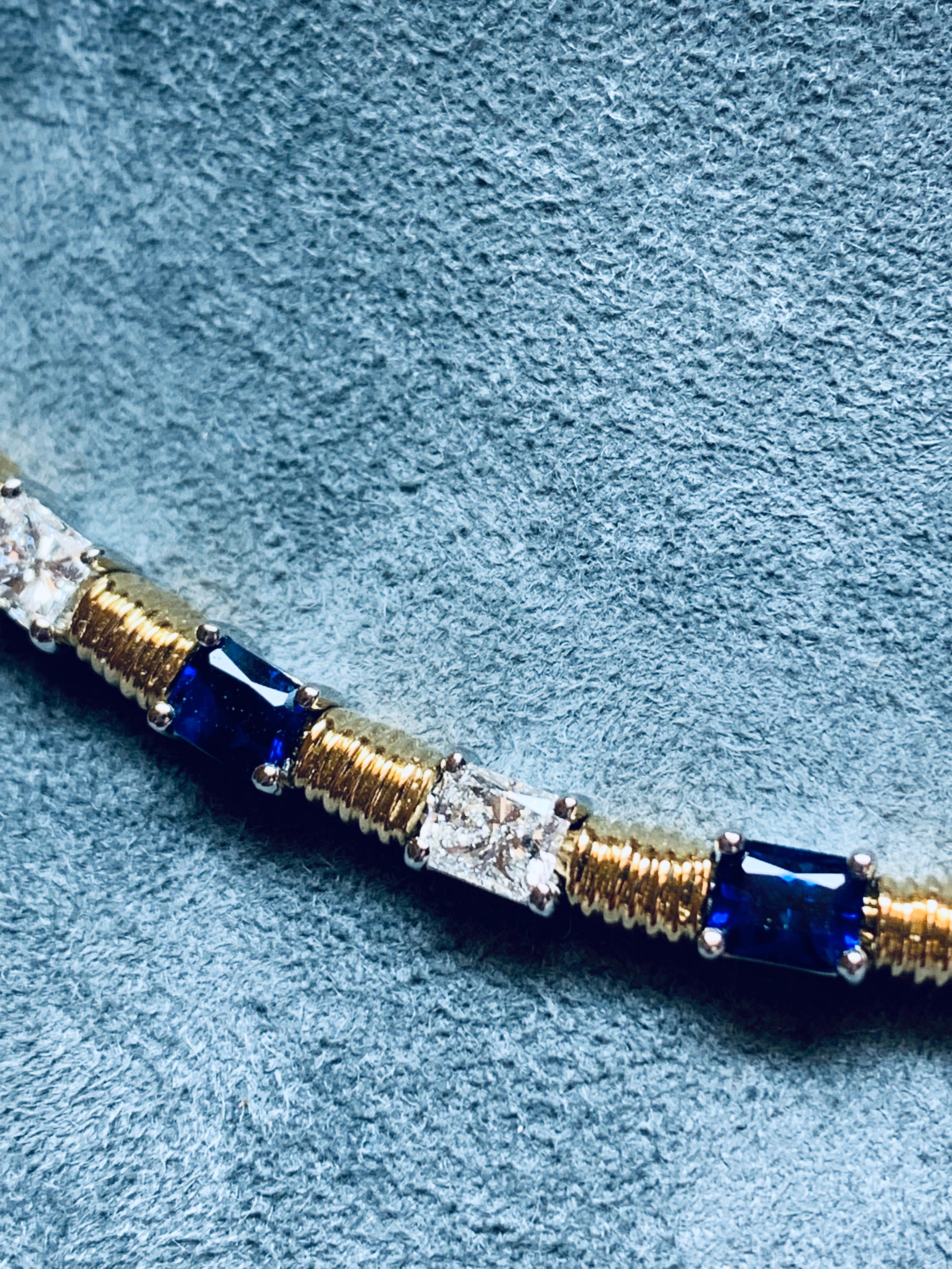 Pictures cannot do this piece justice. Set in a handmade necklace are 8 incredibly rich Emerald cut Blue Sapphires weighing 3.59 carats total and 7 Rectangular Princess cut Diamonds weighing 2.28 carats total. All stones are perfectly matched, and