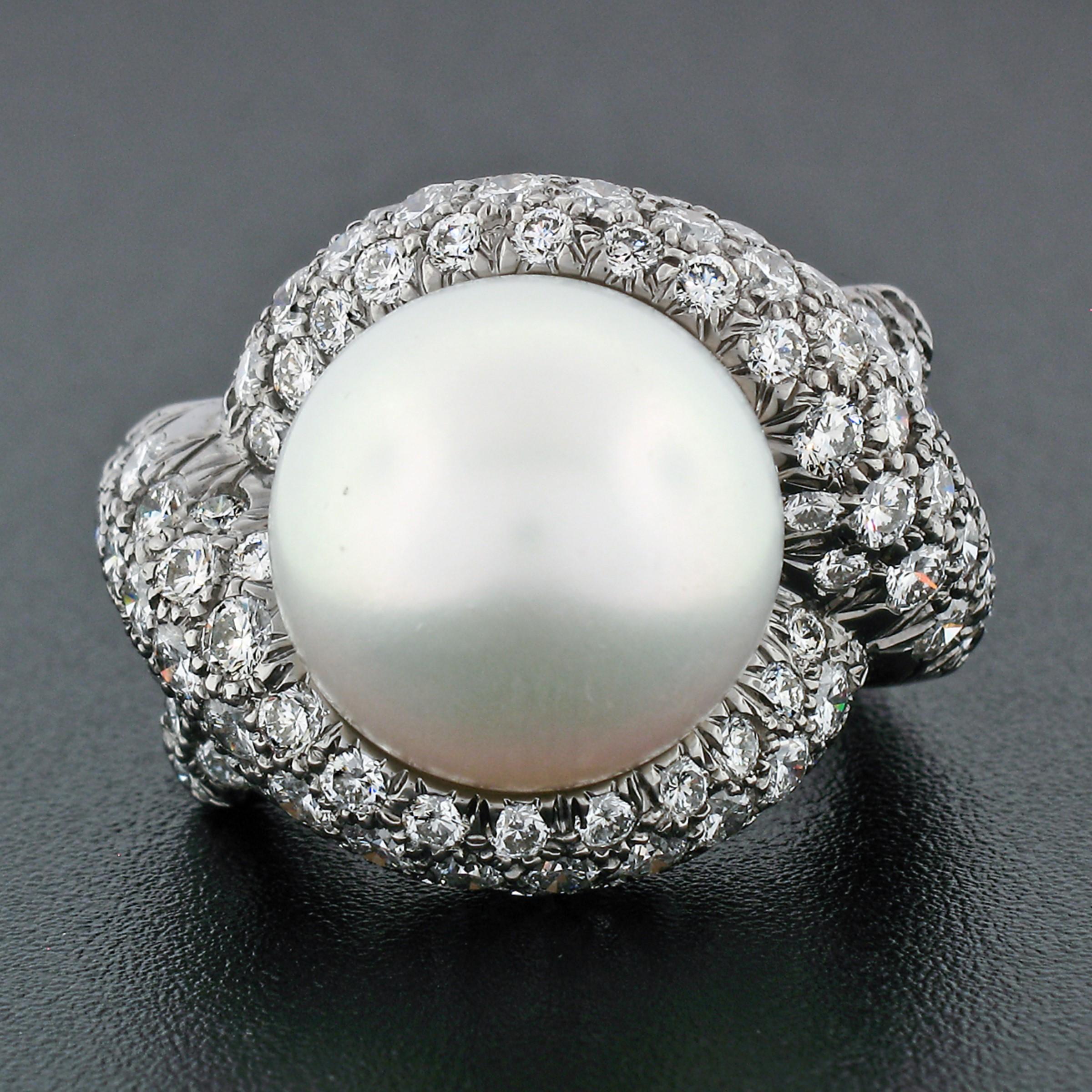 Here we have an absolutely gorgeous statement ring that was crafted from solid 18k gold and plated with black rhodium by Jean Vitau. The ring features an approximately 13.4mm, AAA quality, round cultured pearl stem set at its center. The large pearl