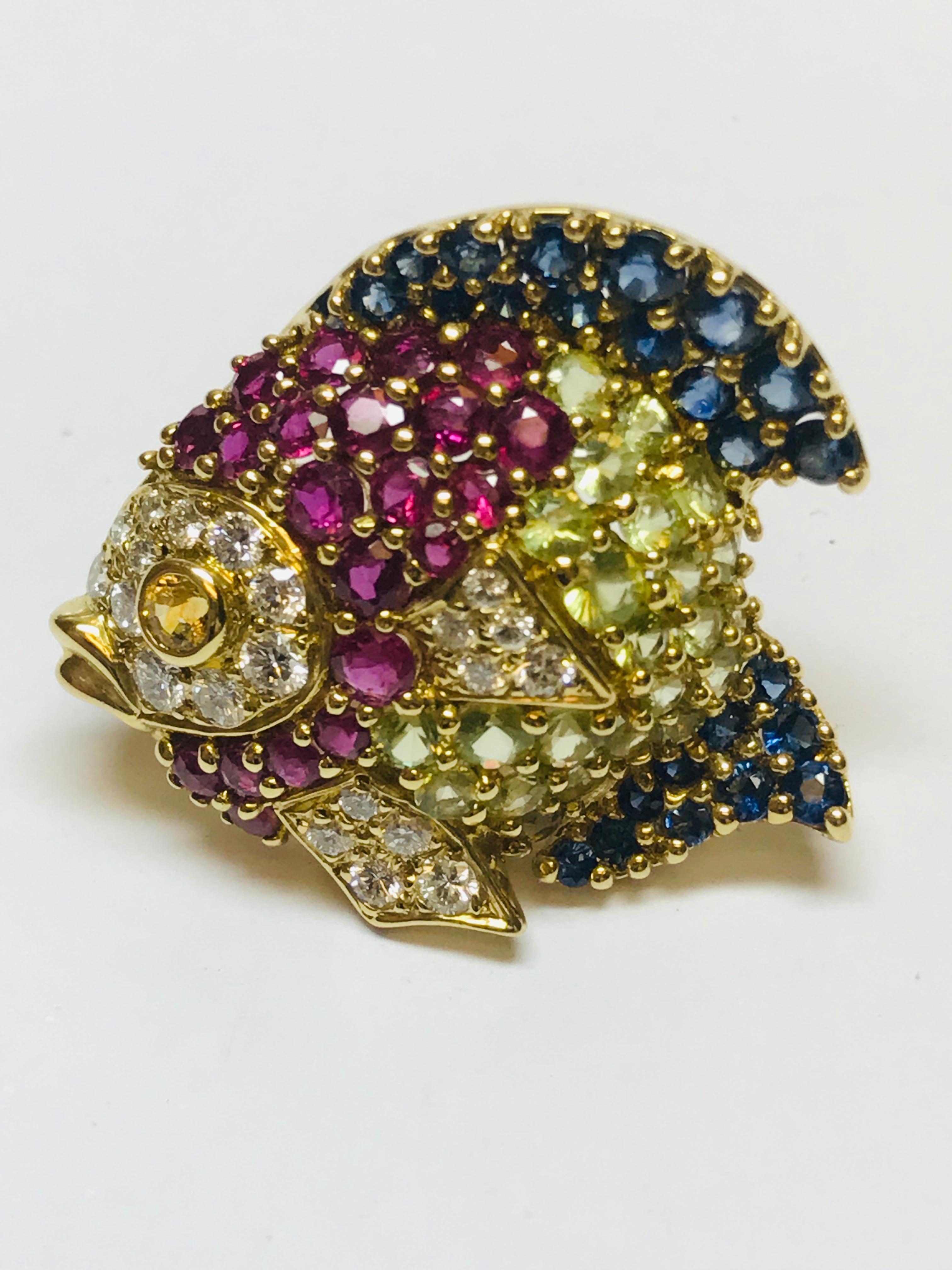 Using the very unique color combination of Blue Sapphire, Ruby and Peridot with a dash of diamonds and a yellow sapphire eye really make this fish swim!!! This pin can be altered to be worn as a pendant as well.