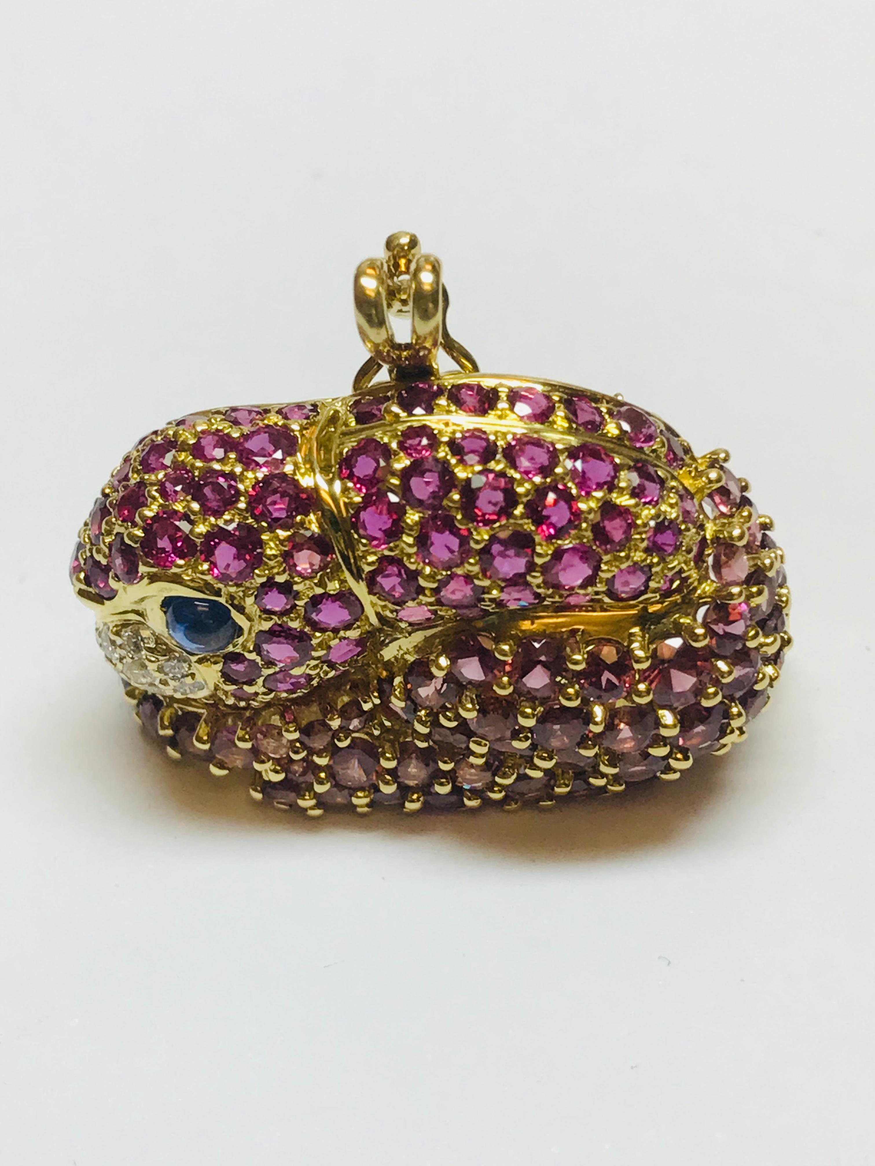 This very unique combination of Pink Garnets on the bottom and Rubies on the top subtly show this precious Rabbit with her ears back. The addition of diamonds on the nose and a Sapphire eye finish her off exquisitely. There are 3.70 carats of Pink