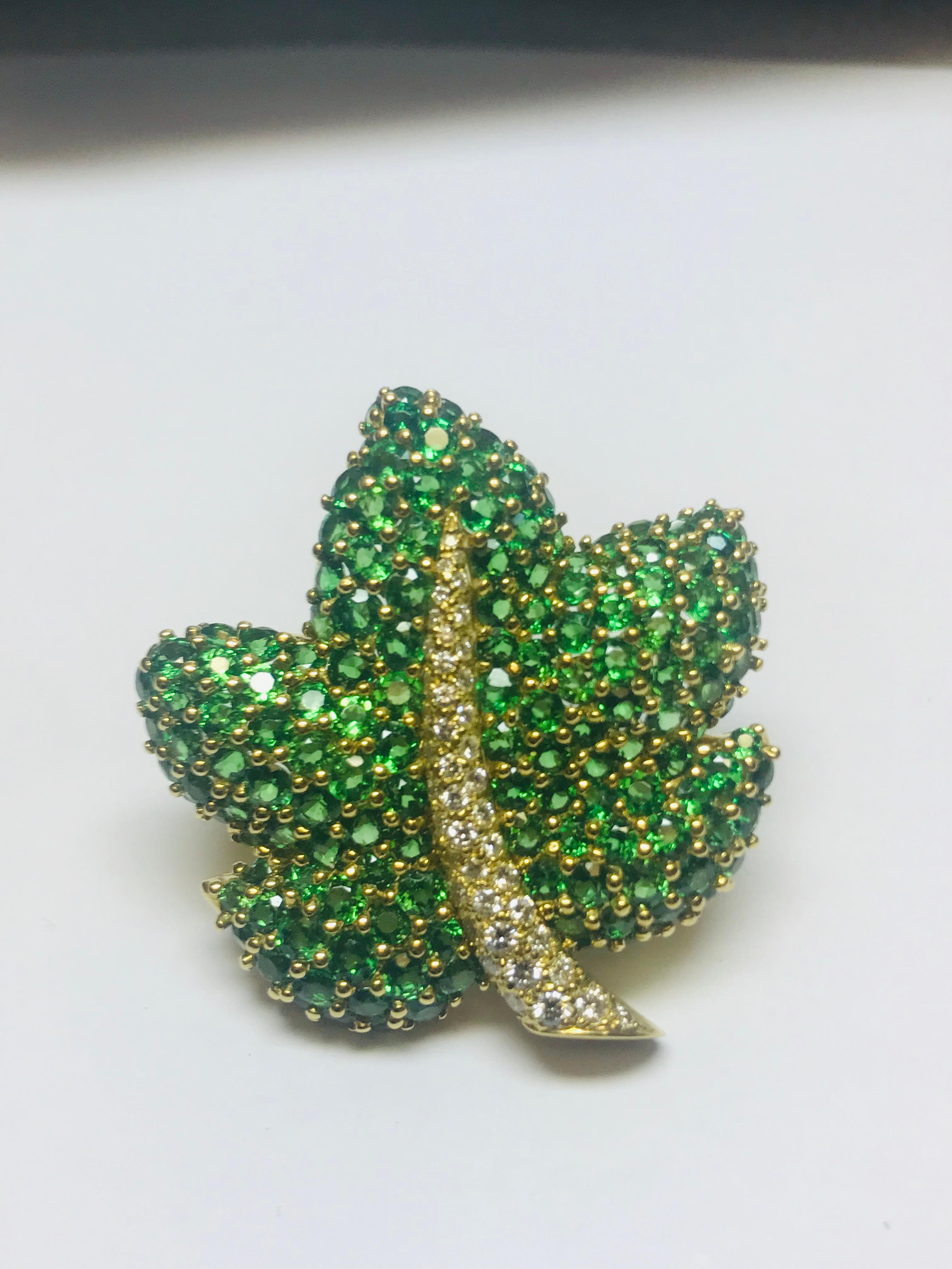 This incredibly vibrant Maple leaf brooch, designed and manufactured by Jean Vitau, has 13 carats of incredibly matched rare Tsavorite Garnets and .74 carats of white diamonds. There's a double pin to insure stability when worn and can also be