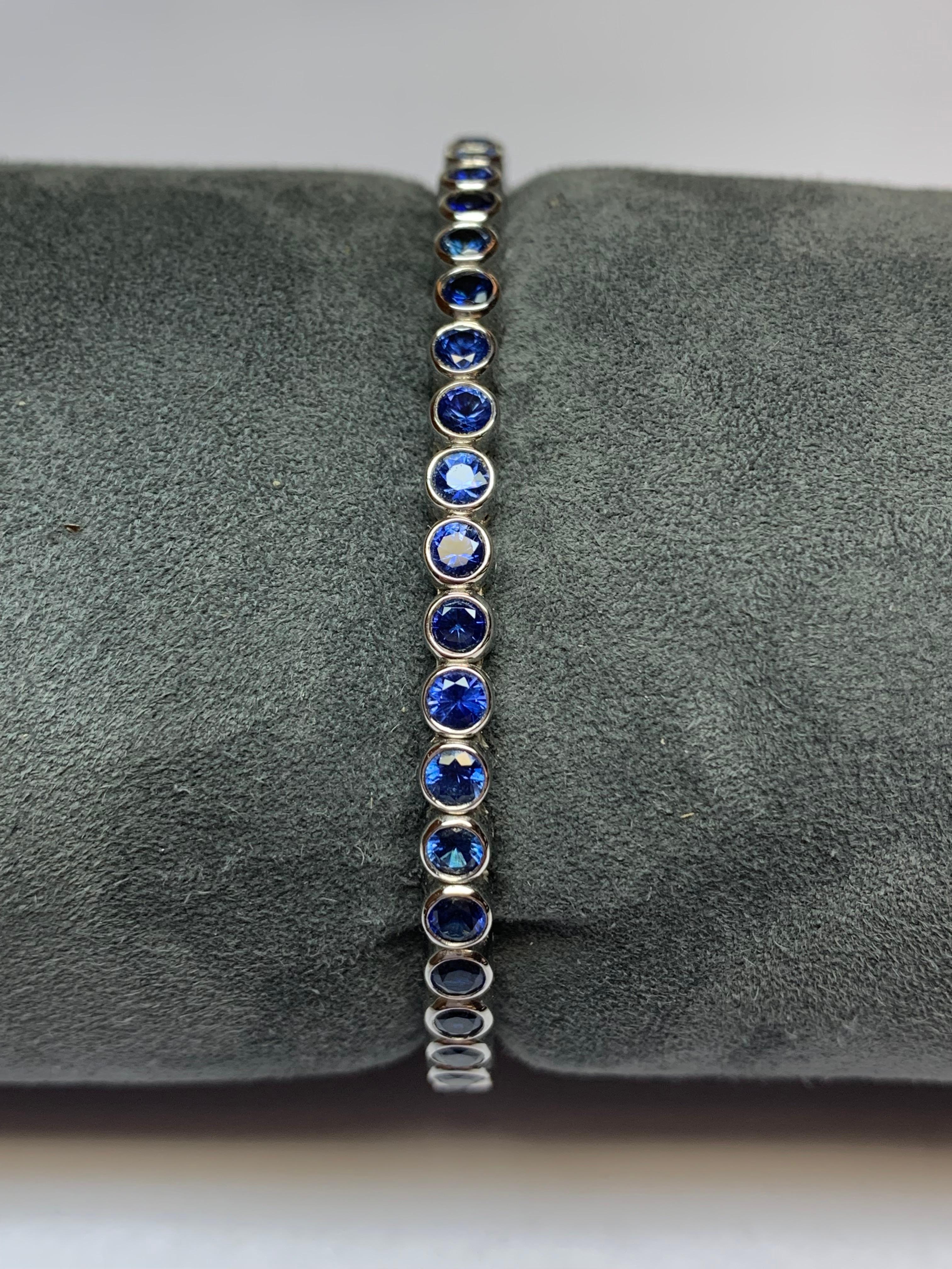 This Jean Vitau classic spring loaded bangle bracelet set with 5.16 carats of cornflower Blue Sapphires, all perfectly bezel set, is incredible. The triple spring action allows it to sit securely and comfortably on any wrist. We make this piece in