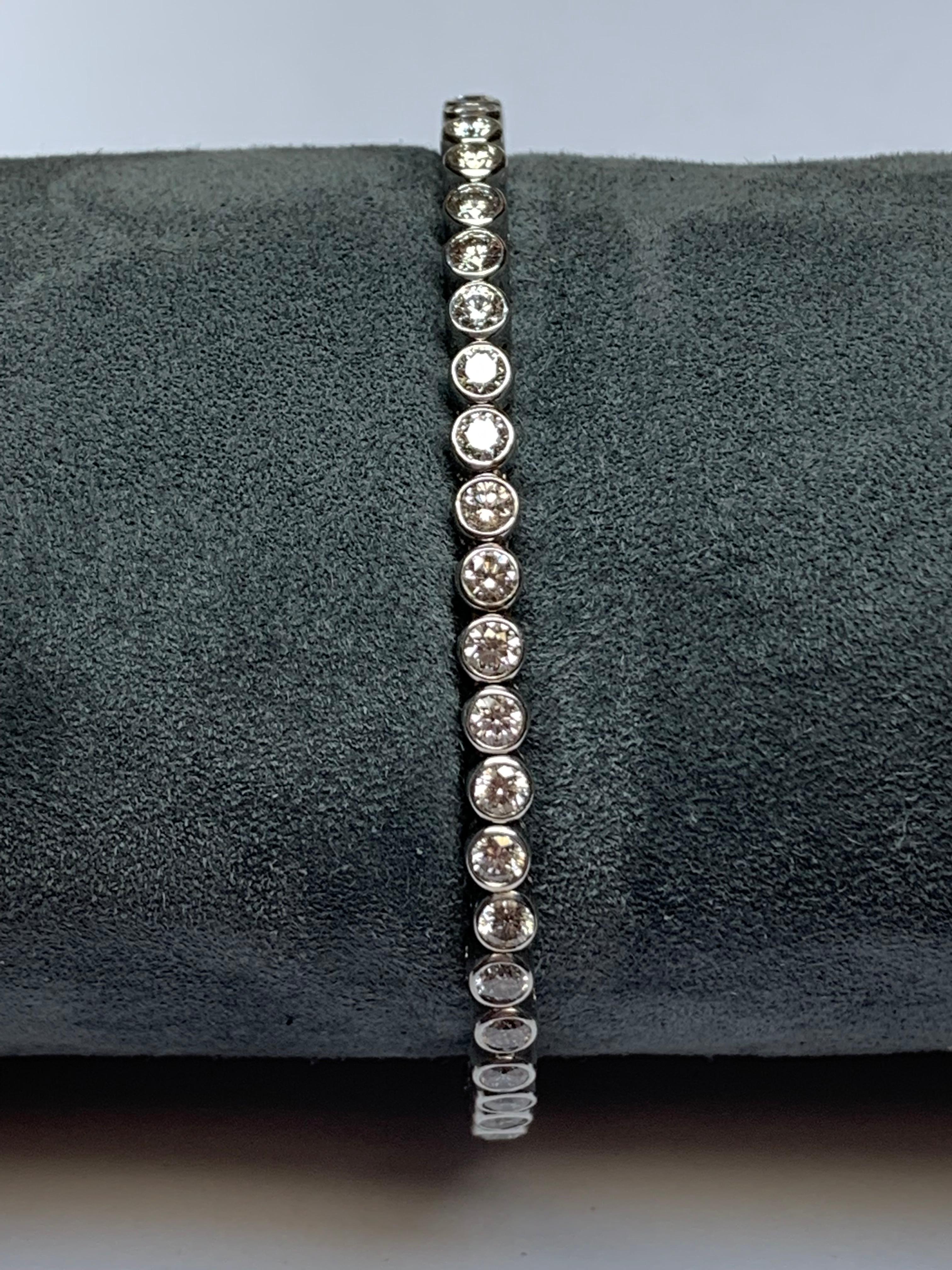 This Jean Vitau classic spring loaded bangle bracelet set with 4.35 carats of G+ color VVS clarity diamonds, all perfectly bezel set, is incredible. The triple spring manufacturing allows it to sit perfectly on any wrist. We have this piece in Blue