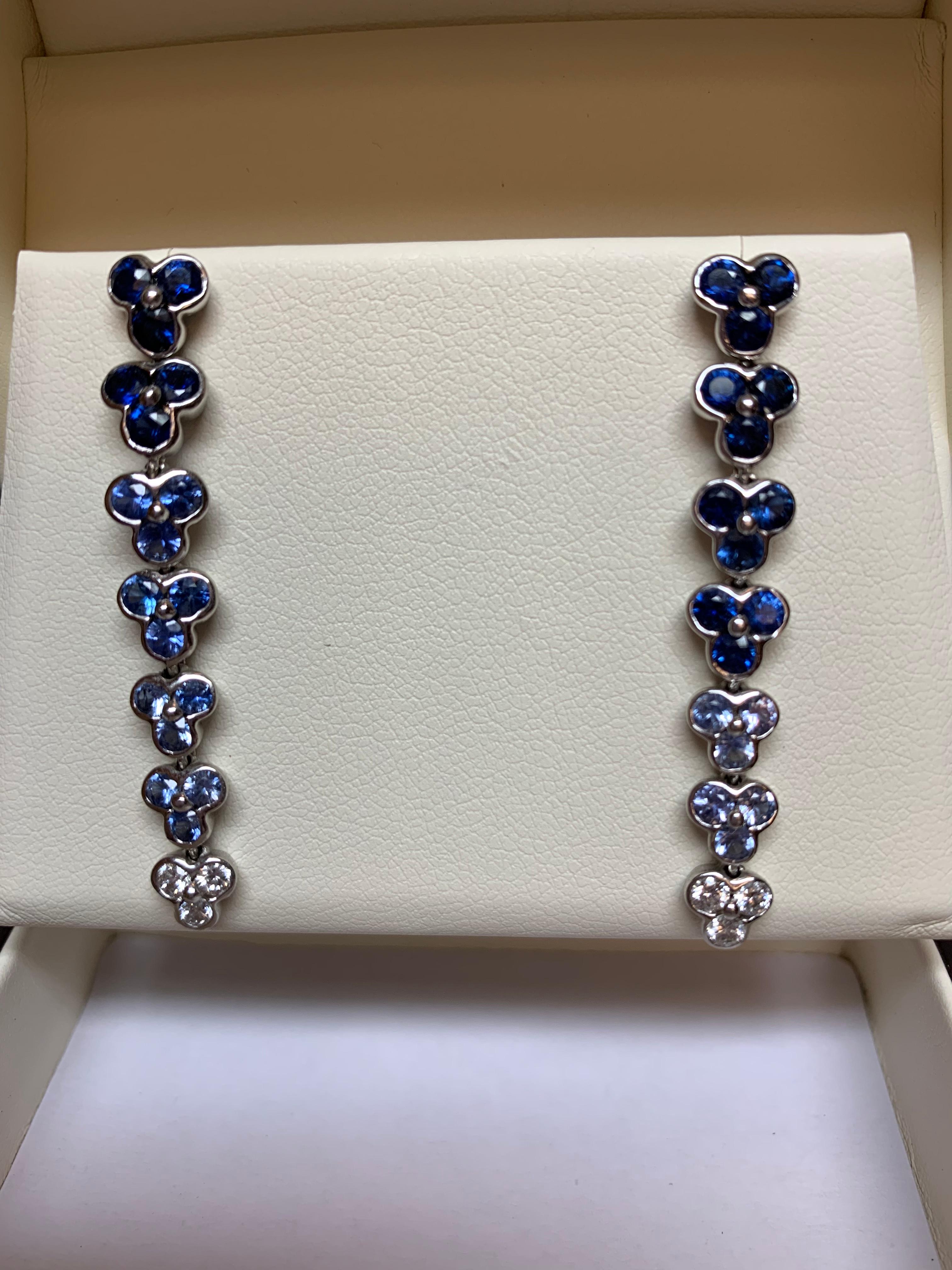 The Wisteria collection is one that has a graduation of color. Theses Blue Sapphire earring start at the top with a rich blue and taper down to lighter blue and end with a diamond. They have an incredible look on the ear. They contain 3.45 carats of