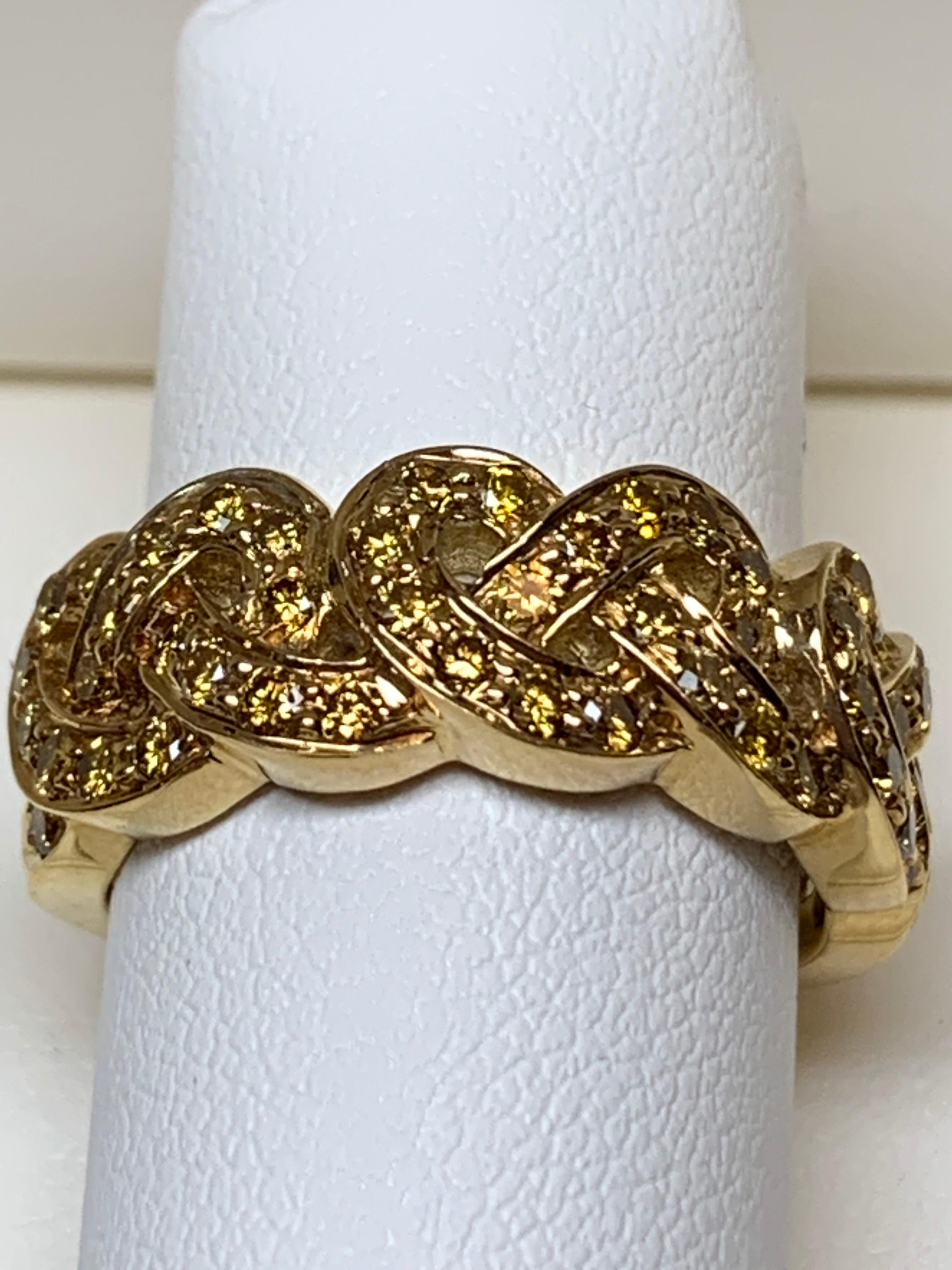 This beautiful woven ring contains .78 carats of precious Yellow Diamond mounted perfectly in 18K yellow gold. The diamonds go half way around but could be made all around as well.