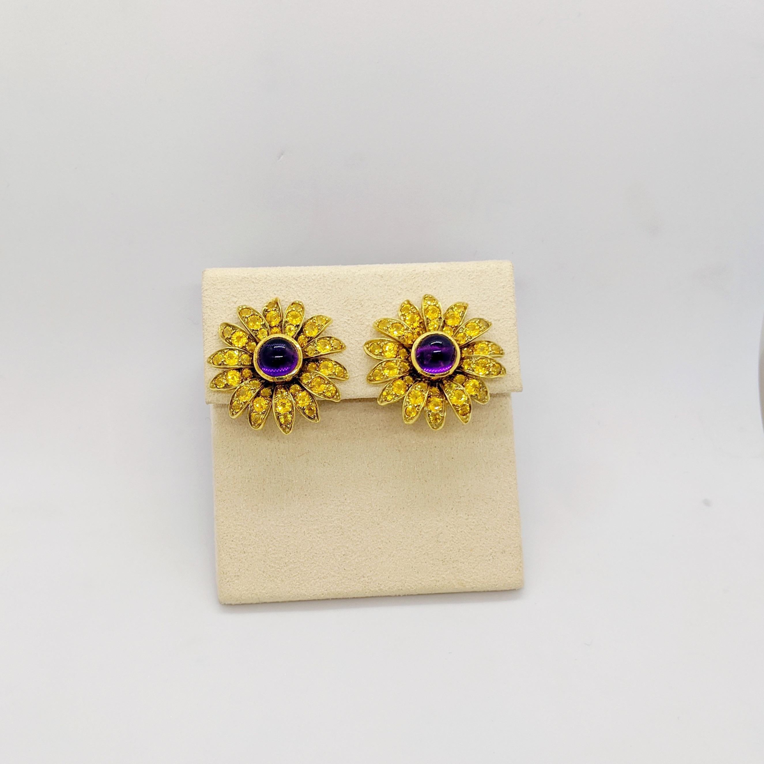 Hello Sunshine!!
18 karat yellow gold Sunflower earrings . Each of the 14 petals have been meticulously set with round brilliant cut Yellow Sapphires. The center of the flower is set with a cabachon Amethyst in a bezel setting. Each earring measures