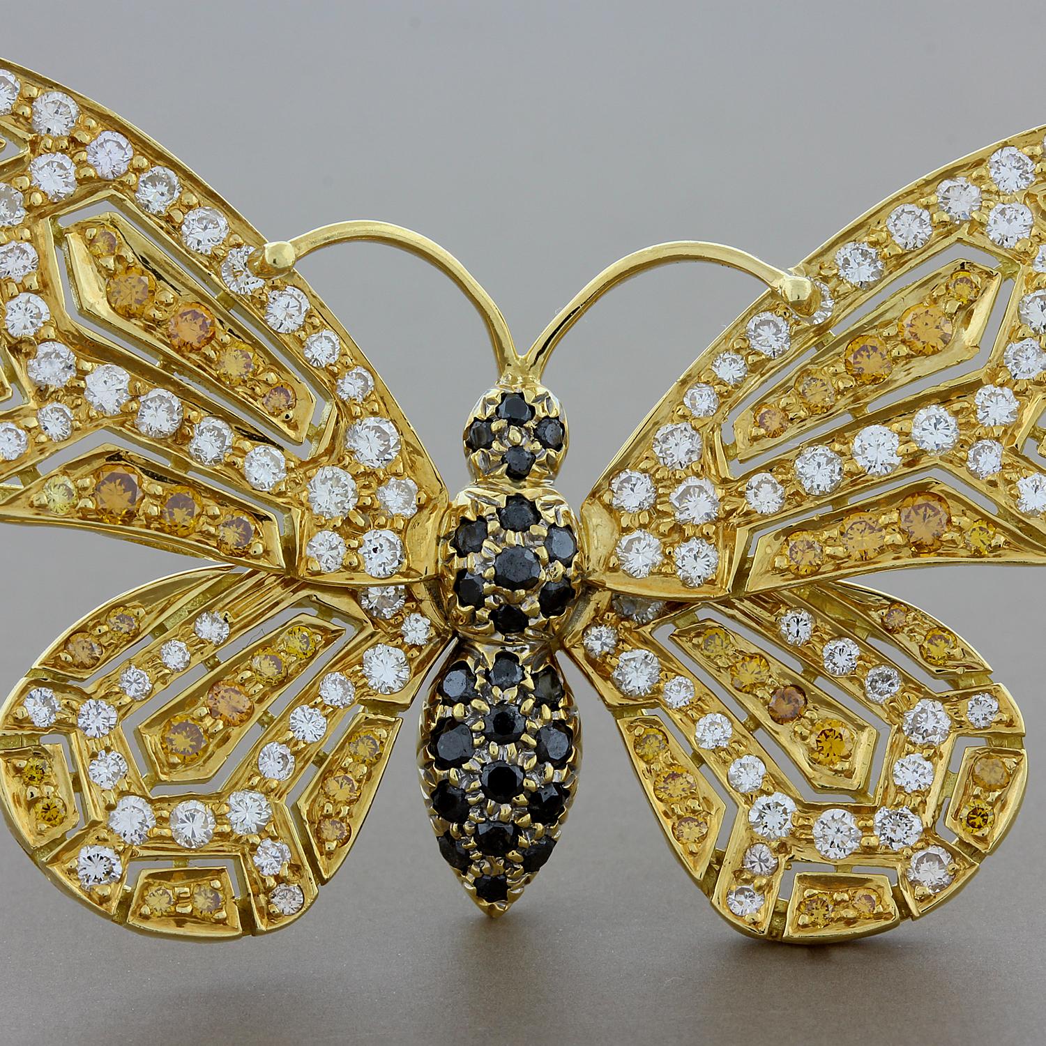Come fly with me! A delightful butterfly brooch from designer Jean Vitau. This refreshing piece features a total of 3.23 carats of colorless, black and orange diamonds set in 18K yellow gold. Like a natural butterfly this brooch has unique colors