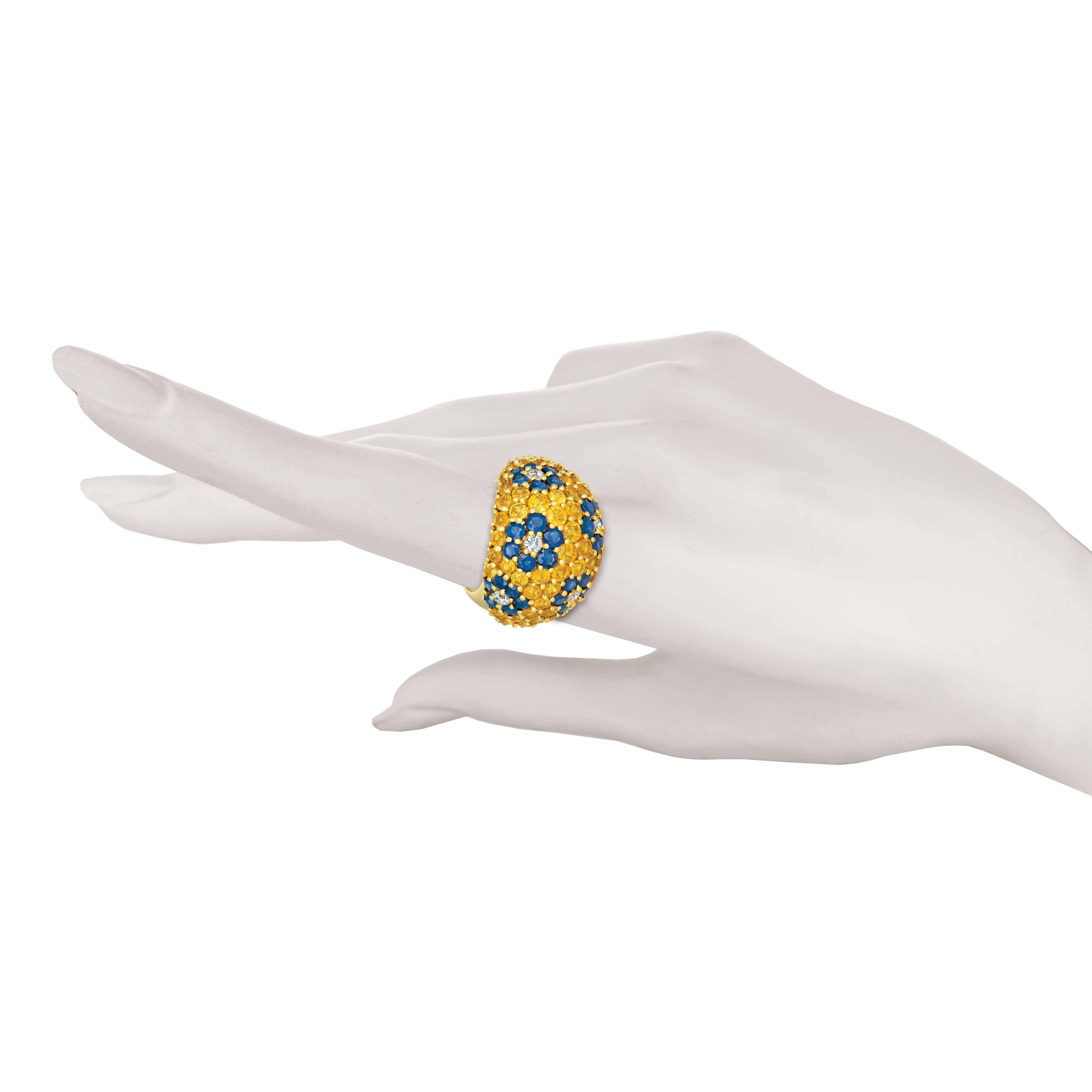 This Jean Vitau dome ring combines the perfect proportions with the wonderful texture of prong set gemstones. The yellow sapphires, weighing 6.75 carats, are a perfect background for the blue sapphires, weighing 4.50 carats, in the floral pattern.