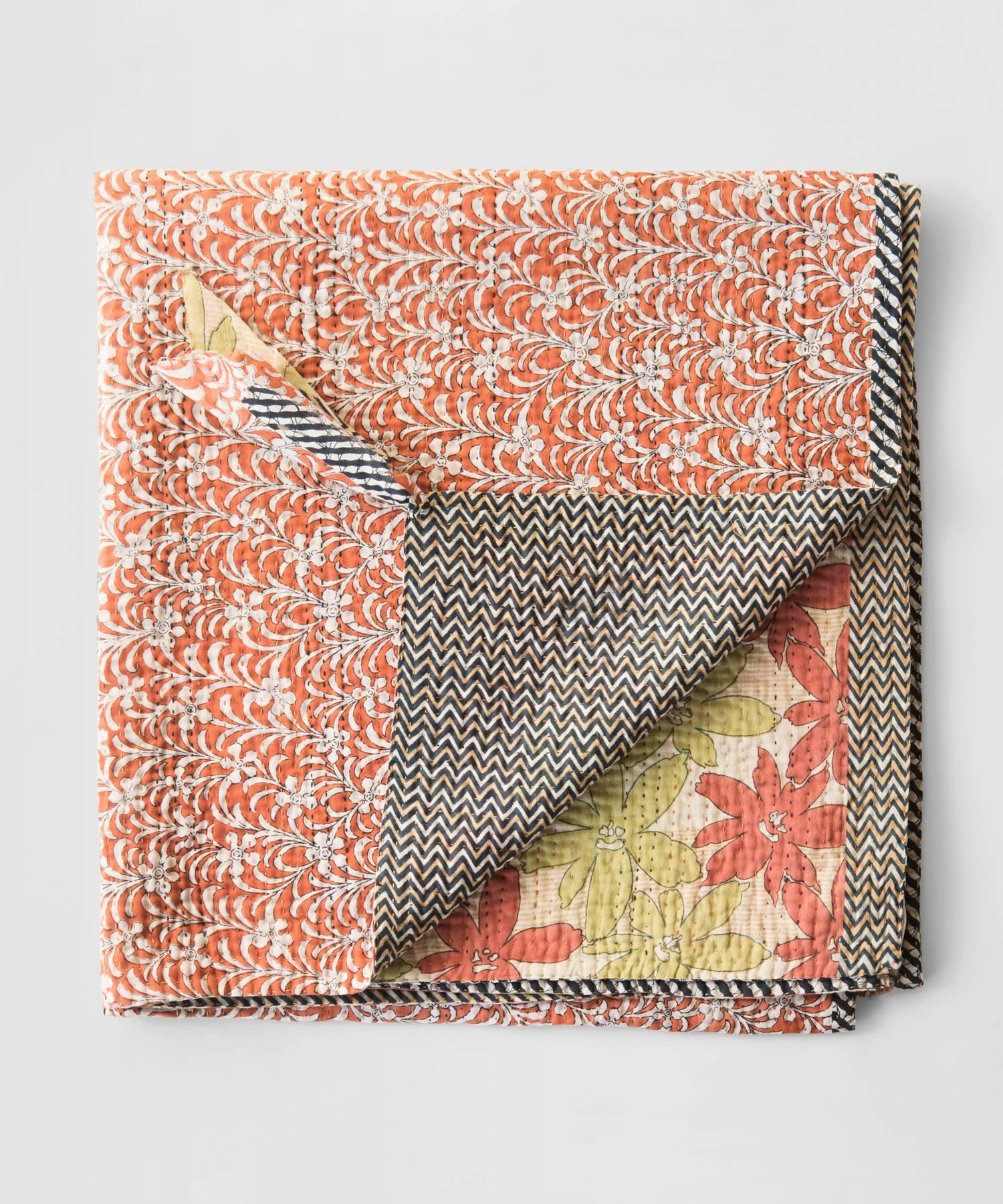 Kantha quilt made from a patchwork of layers of cotton sari joined by a simple running stitch that produces a rippled effect. Each piece is unique.
