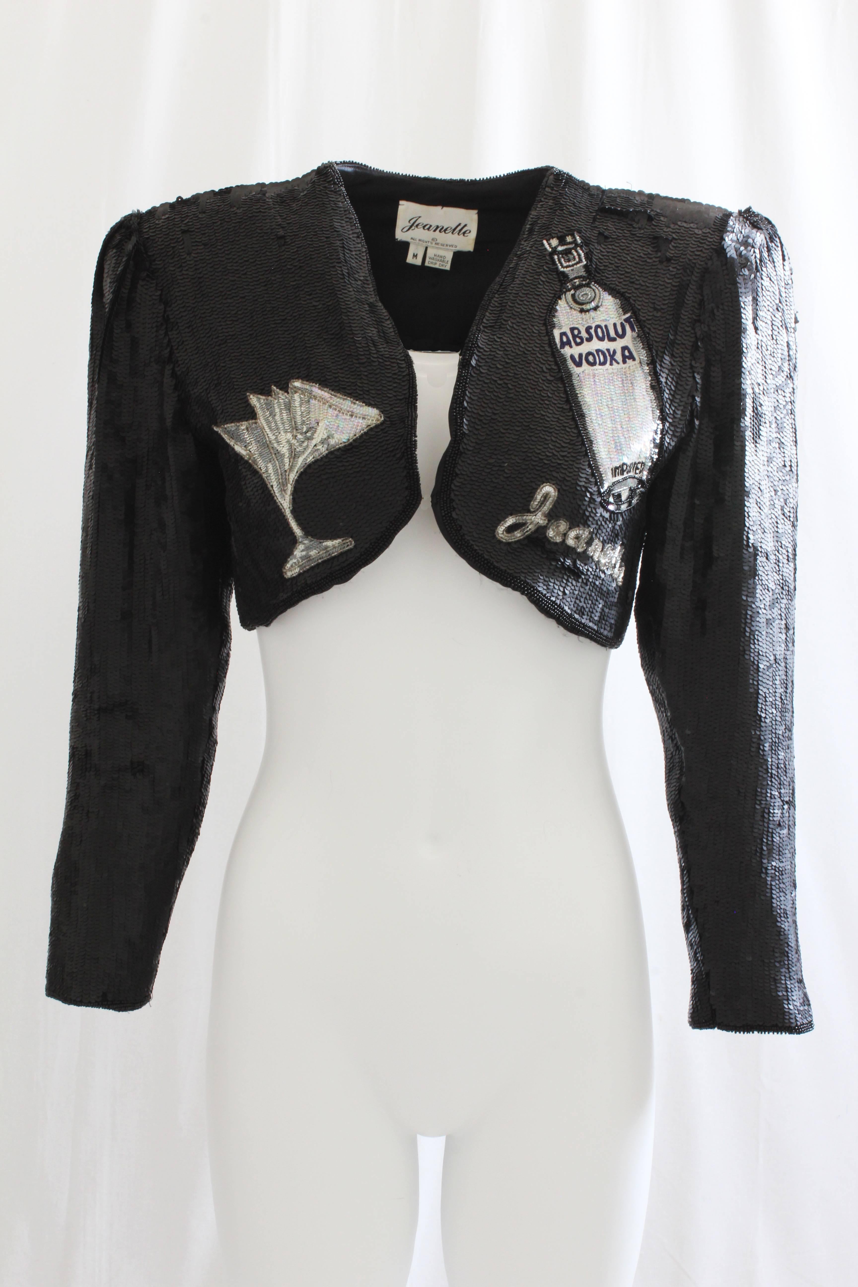 This incredibly rare sequins bolero jacket was designed by Jeanette Kastenberg in 1991 for the Absolut Vodka ad campaign that year.  Covered in tons of sequins, it features the iconic Absolut bottle with cocktail glasses! No fasteners, it is meant