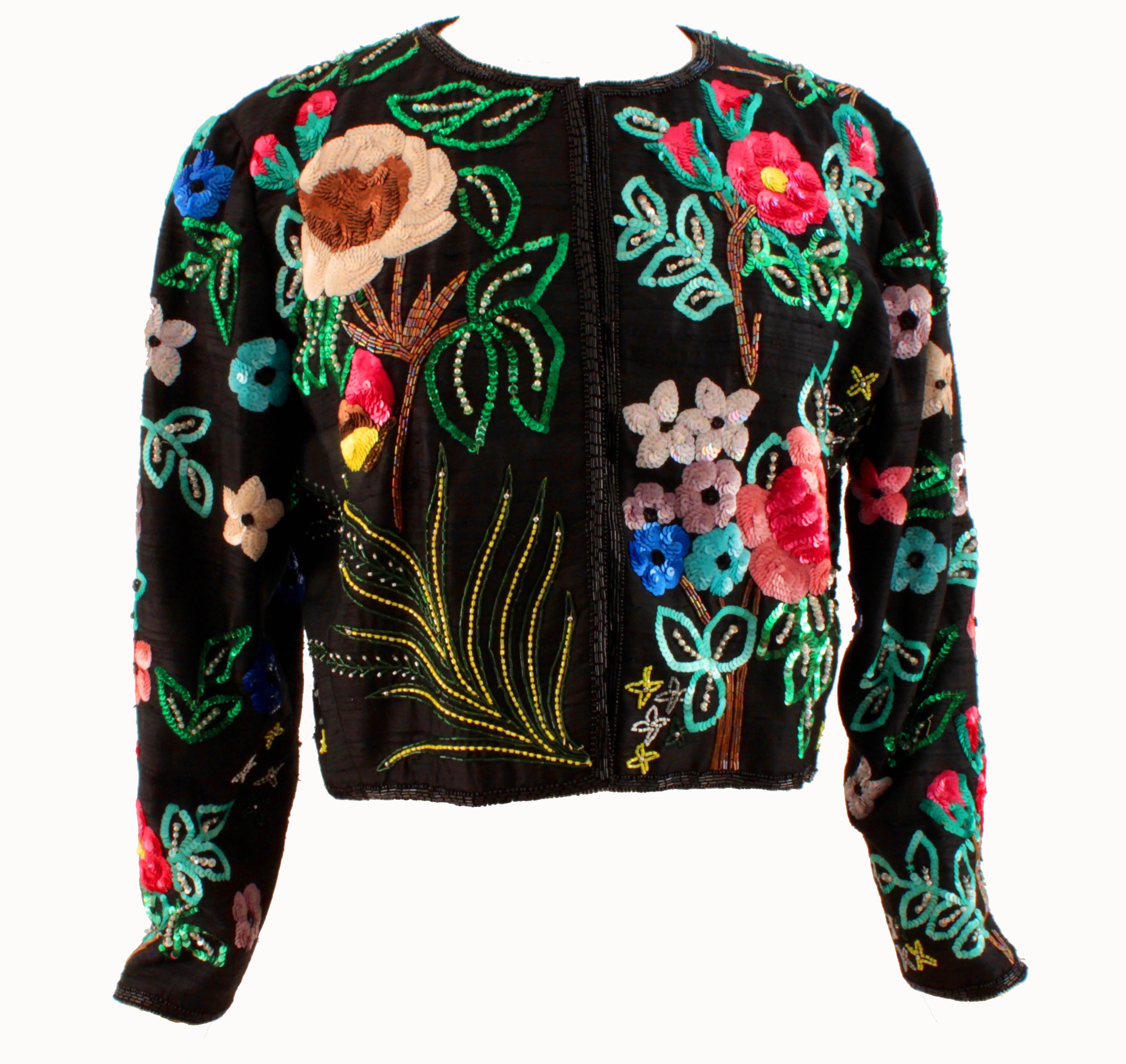 Here's a unique bolero jacket from Jeanette Kastenberg for St Martin, likely made in the 1980s.  Made from black silk fabric, it features bold floral patterns throughout in bright colors. 

Fully-lined in black silk and fastens with hidden snaps. 
