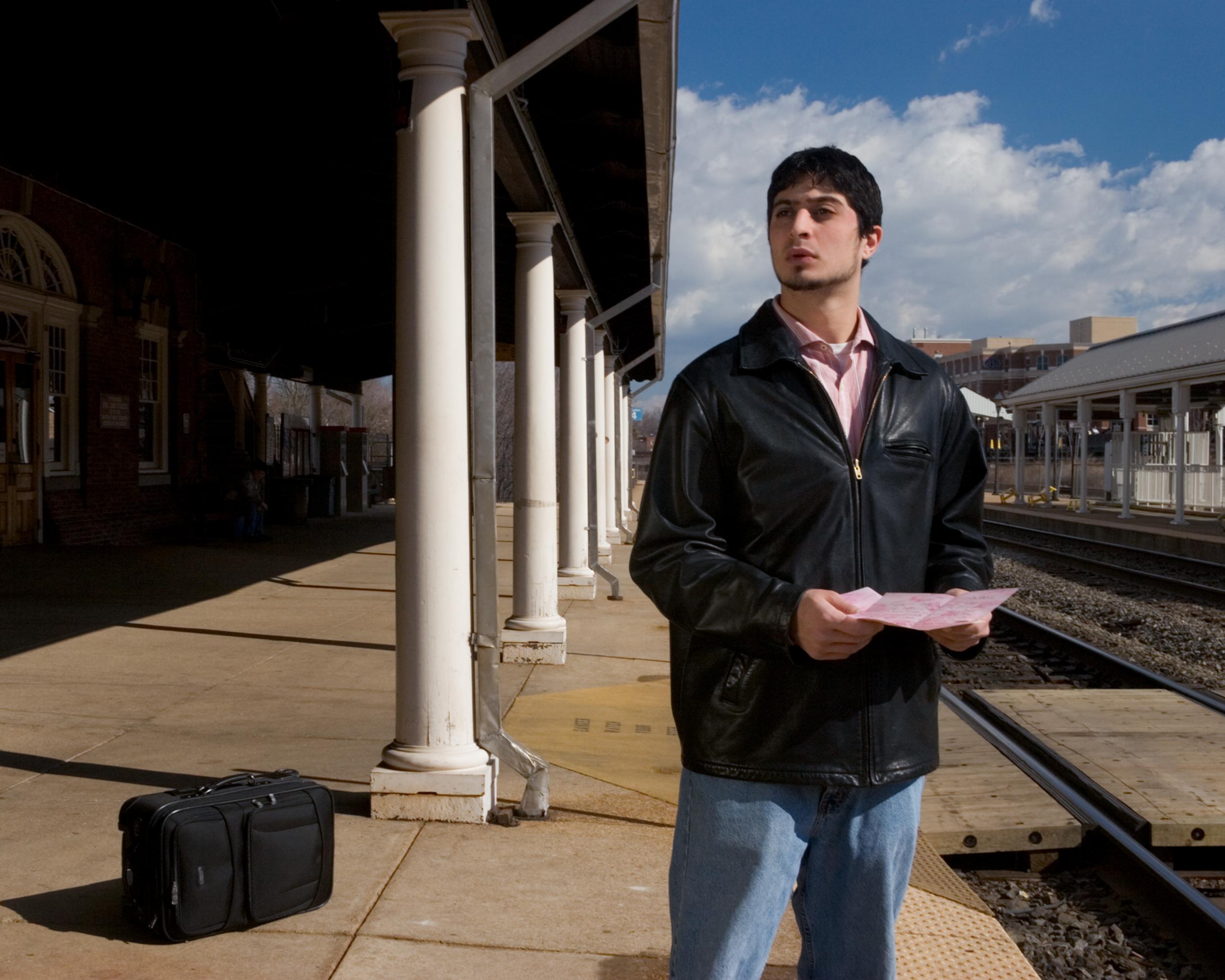 “Easy on the Eyes: Mrs. DeWinter” Portrait of a Beautiful Man at a Train Station - Photograph by Jeanette May