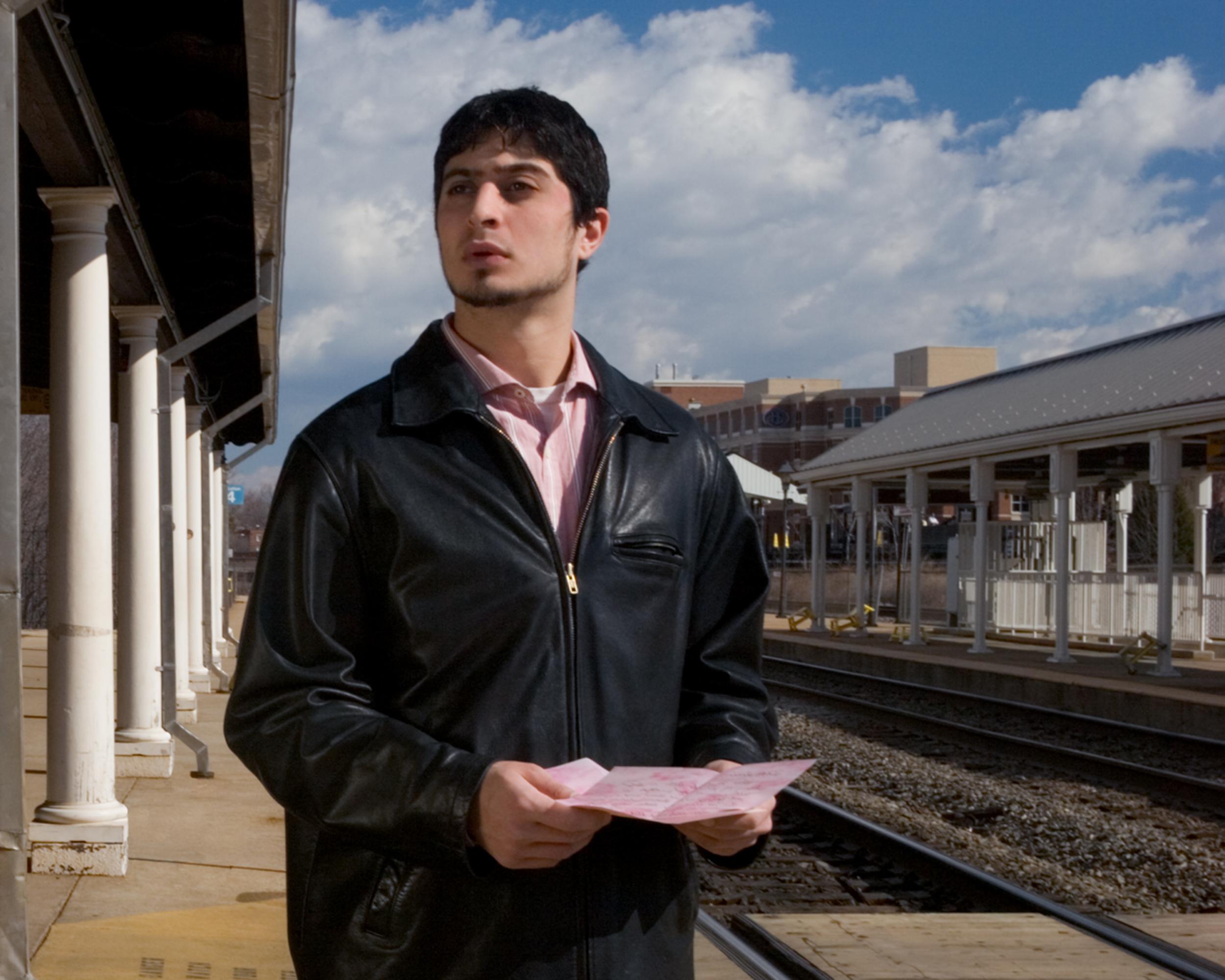 “Easy on the Eyes: Mrs. DeWinter” Portrait of a Beautiful Man at a Train Station - Contemporary Photograph by Jeanette May