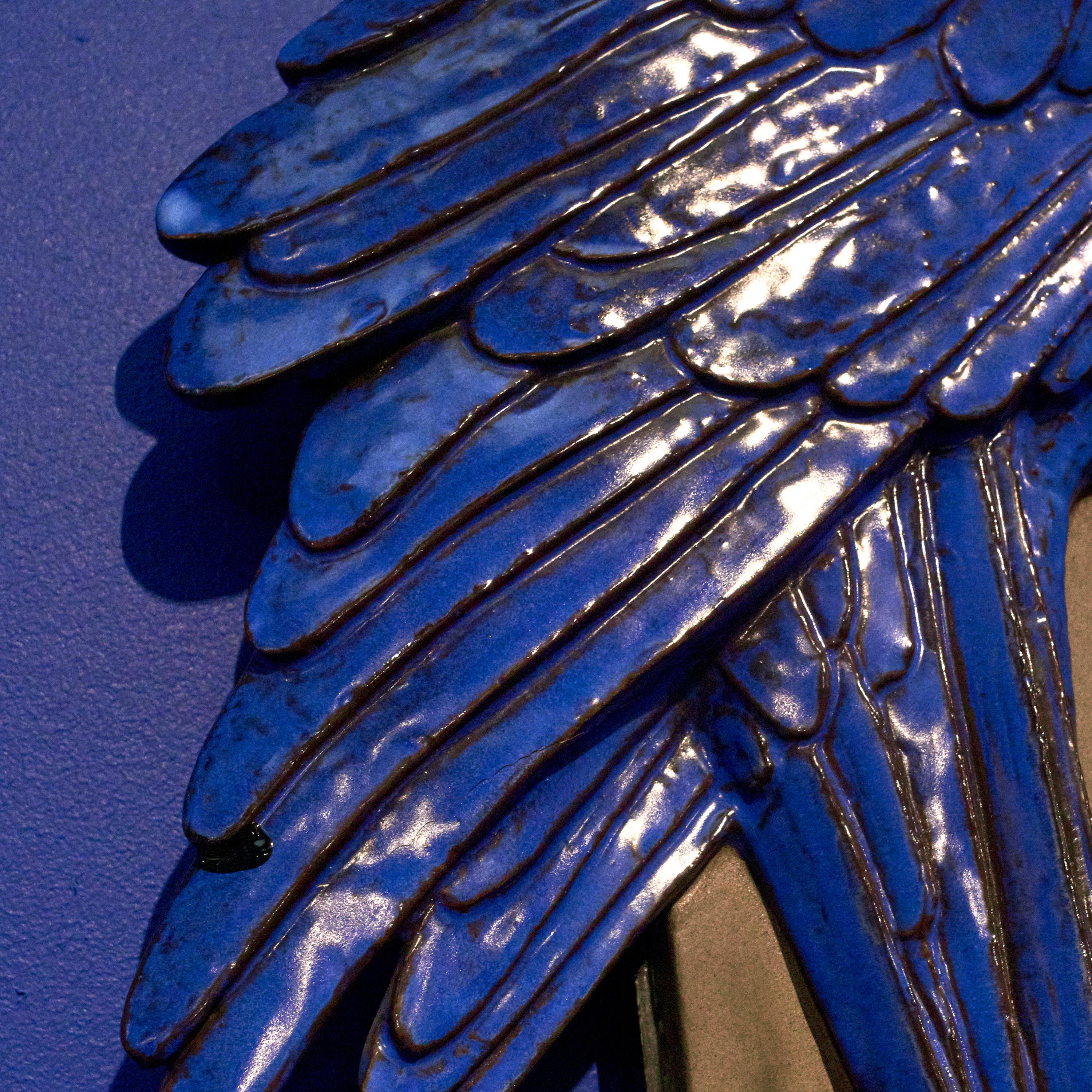Jeanne Grut 1927-2009.
A faience wall relief in the shape of a hyacintara parrot.
Blue glazed faience, branch and background unglazed.
Designed 1961 by Jeanne Grut for Aluminia, Denmark 1961.
Stamped.
 
Aluminia was a Danish factory of faience