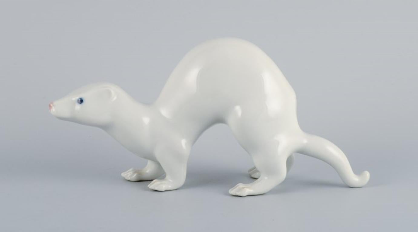 Jeanne Grut for Royal Copenhagen.
Porcelain figurine of a mink. 
Model number 4562.
In perfect condition.
First factory quality.
Dimensions: H 11.5 x L 25.0 cm.
