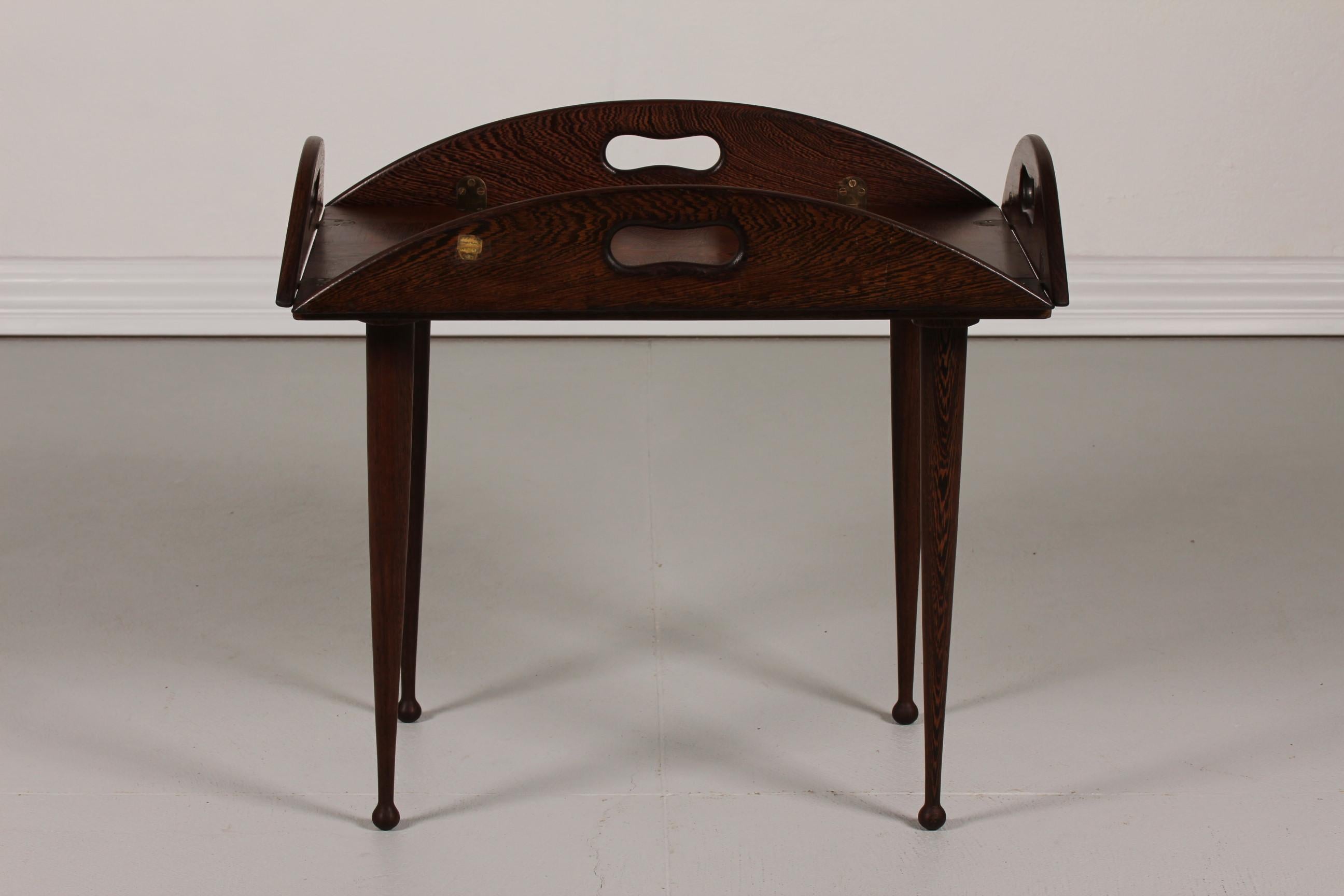 Butlers tray attributed to the danish designer Jeanne Grut.
It is made of wengé with 4 drumstick legs.
The table has underneath a handwritten label with among other Jeanne Gruts name 
- see photo

Measures: Length 72/92 cm
Width 49/68