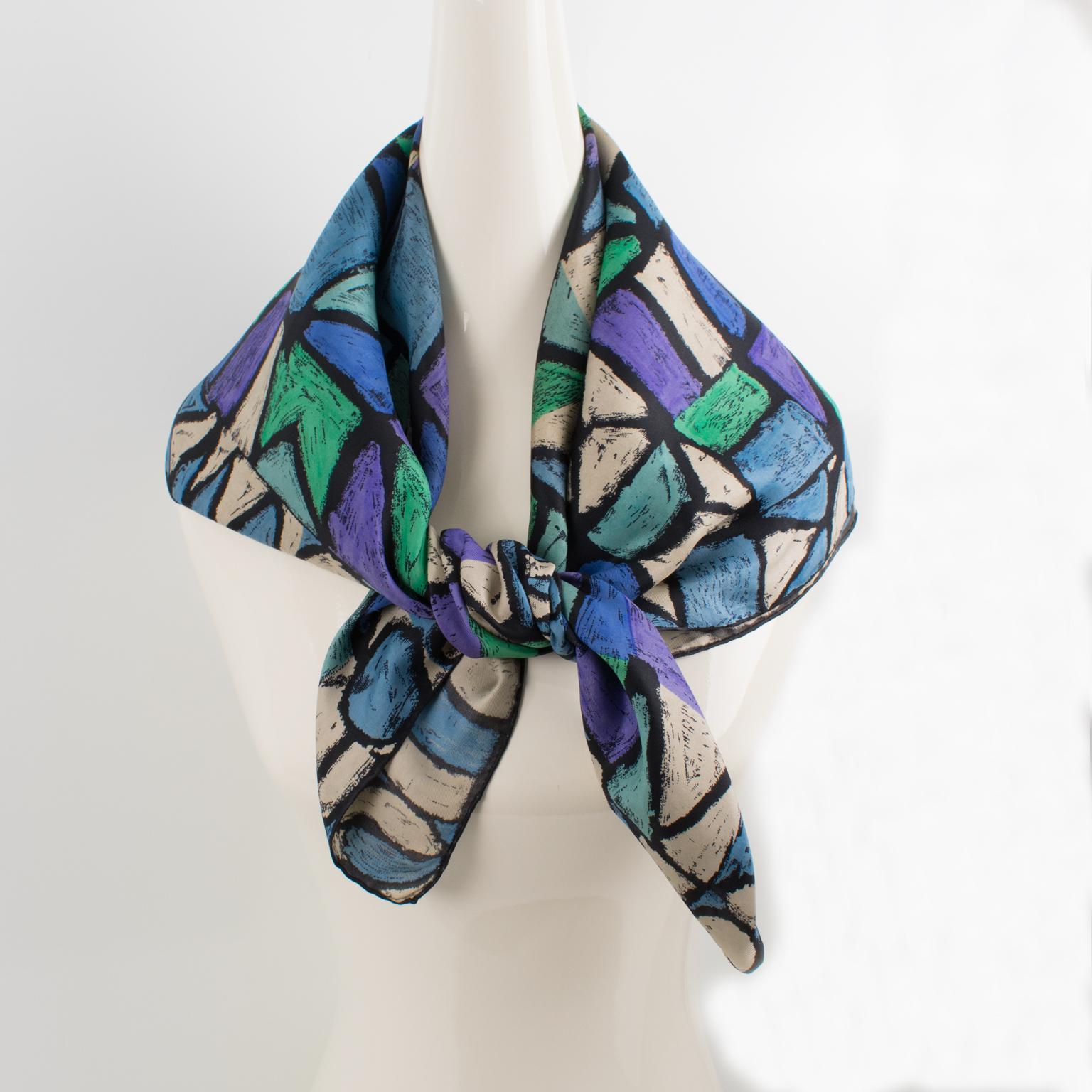 Antonio Castillo designed this lovely silk scarf for Jeanne Lanvin Paris in the 1950s. The design features graphic letters printed in blue, turquoise, and purple colors and is signed on the bottom right corner by Jeanne Lanvin and Castillo. The