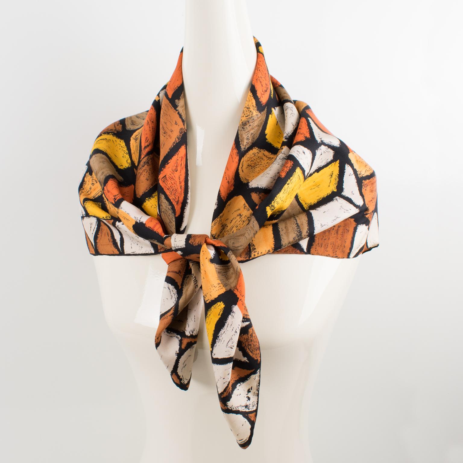 Antonio Castillo designed this lovely silk scarf for Jeanne Lanvin Paris in the 1950s. The design features graphic letters printed in chocolate brown, rust, and marigold colors and is signed on the bottom right corner by Jeanne Lanvin and Castillo.