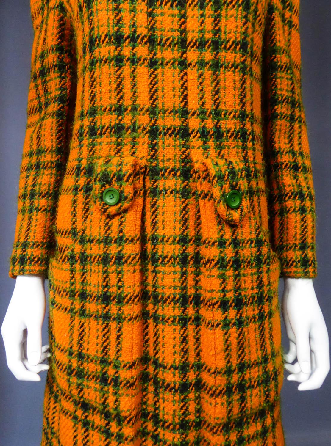 Circa 1968/1970
France

Mini dress Demi Couture Jeanne Lanvin in Scottish tartan dating from the Yé-yé period of the late 1960s. Thick orange wool knit with green and black check. Straight cut slightly flared with small turtleneck and long sleeves.