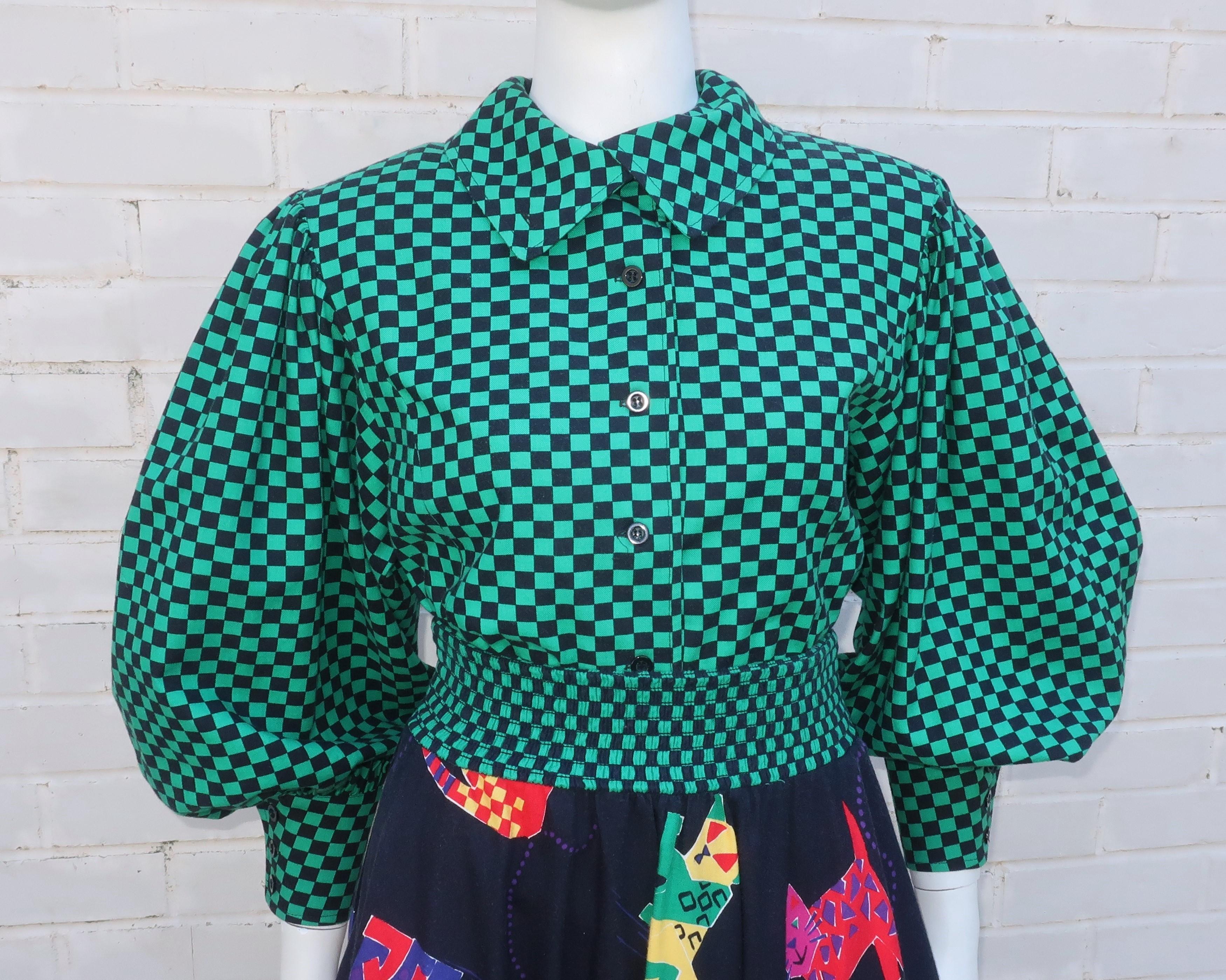 The husband and wife team making up the creative force of San Francisco based Jeanne Marc clothing line were well known for their artfully designed garments and this whimsical 1980’s two piece dress is no exception.  The ensemble features a New Wave