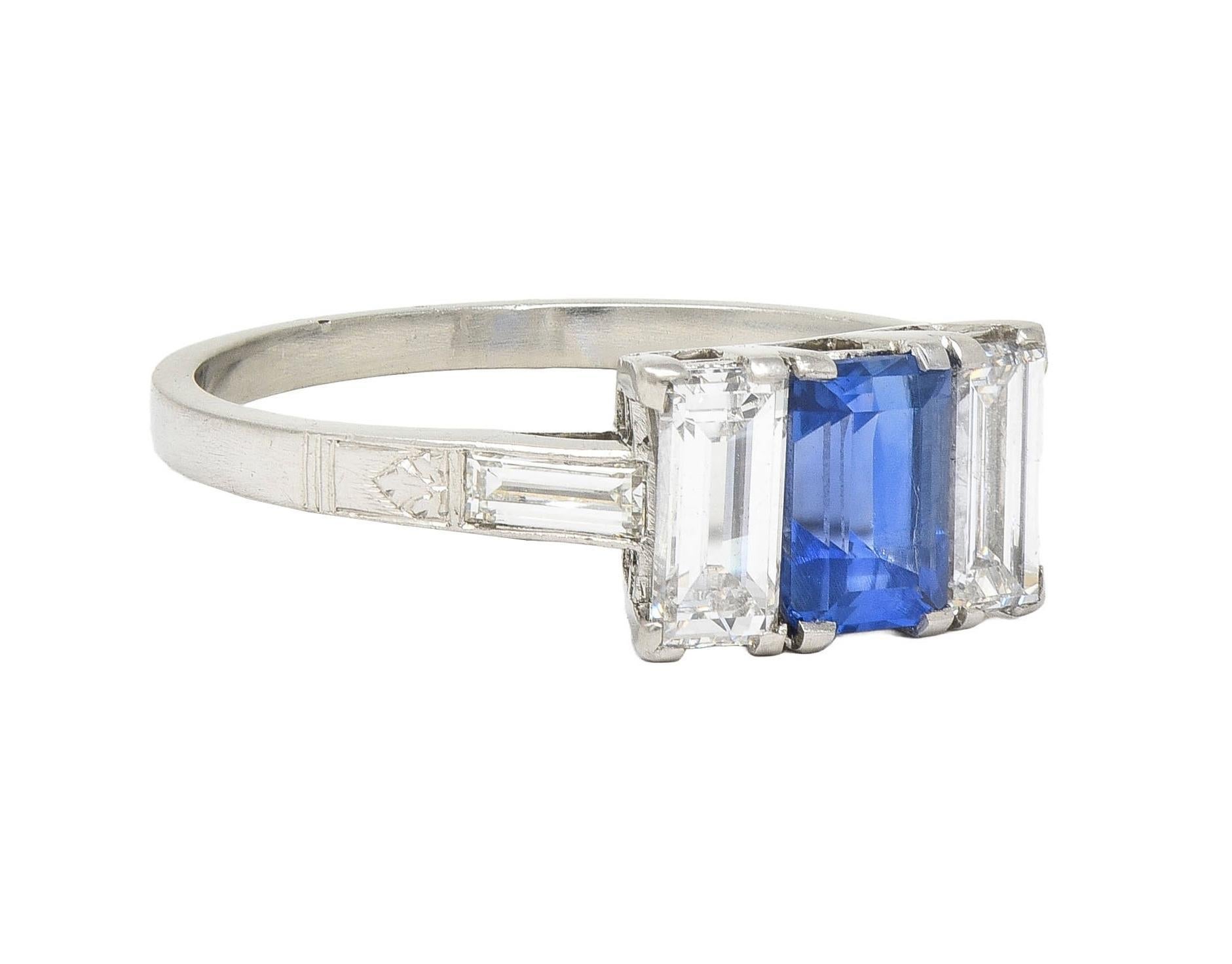 Centering an emerald cut sapphire weighing approximately 0.93 carat 
Transparent medium blue in color and prong set in basket
Flanked by baguette cut diamonds prong set in baskets
Weighing approximately 0.70 carat total  - G color with VS2