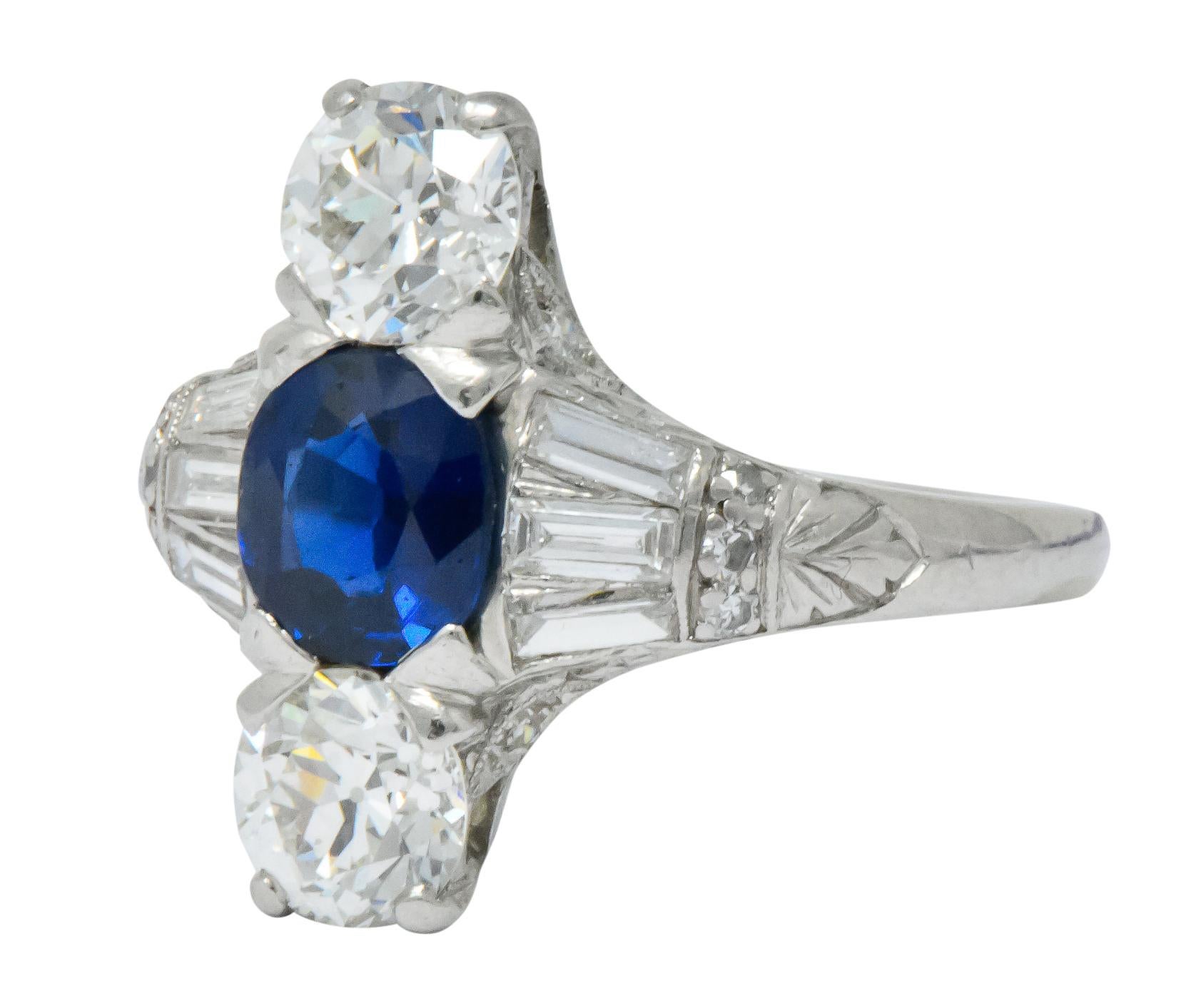 Centering a Cambodian oval sapphire weighing 1.10 carats, deep royal blue with no evidence of heat treatment

Accompanied by two old European cut diamonds, weighing approximately 1.20 carats total, G/H color and VS clarity

Accented by single and