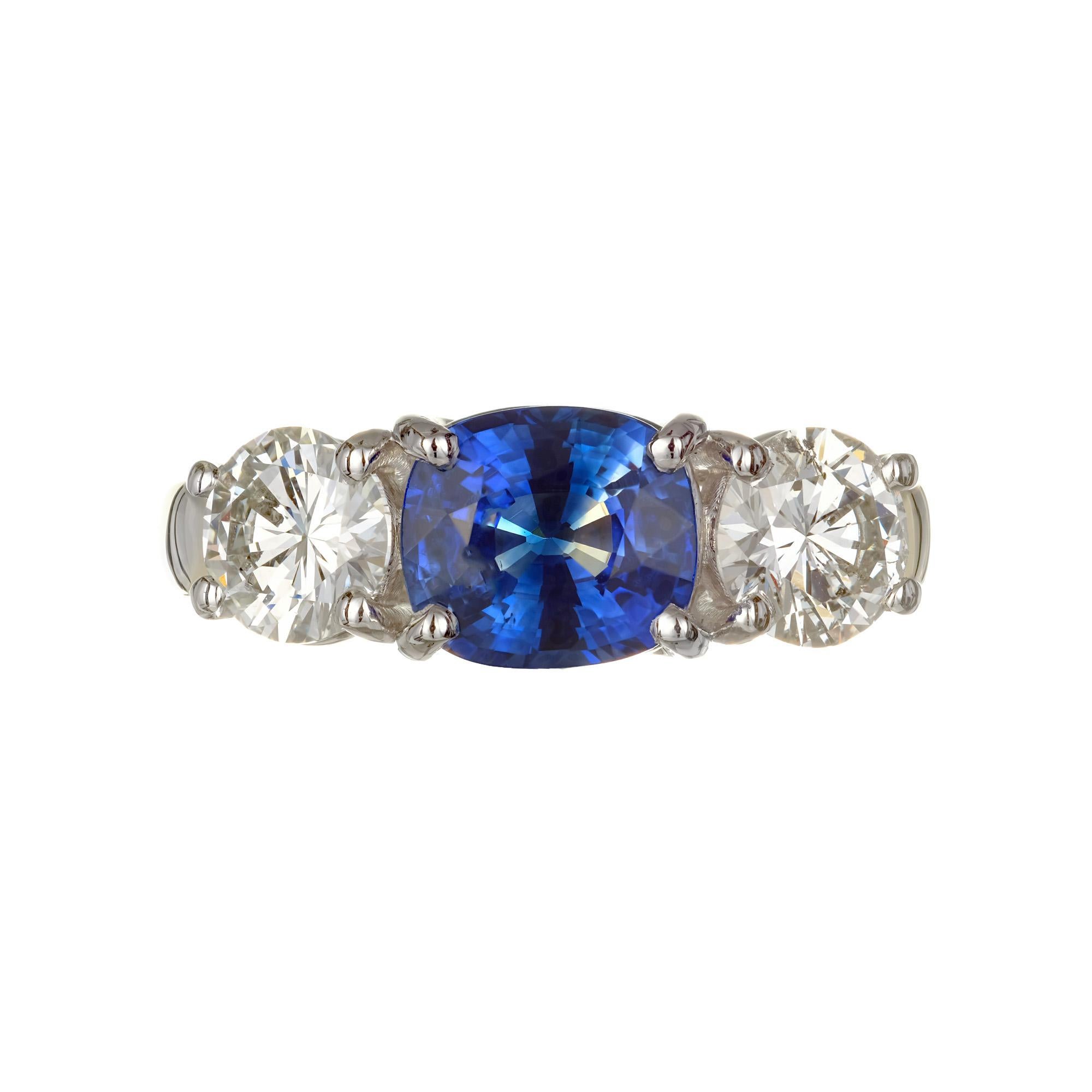 Jeff Cooper sapphire and diamond three-stone engagement ring. Set with two bright sparkly brilliant cut diamonds on each side of a GIA Certified Oval sapphire set in 18k yellow gold and platinum. 

1 cushion cut oval blue sapphire Approx. Total