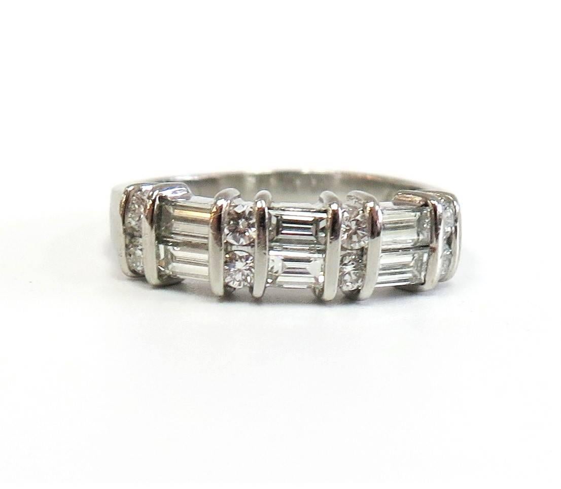 This Round and Baguette-cut Diamond Wedding Band by designer Jeff Cooper will enhance any engagement ring with its fiery sparkle and shine. Crafted in Platinum, the ring showcases a stunning combination of eight round-cut, channel-set diamonds and