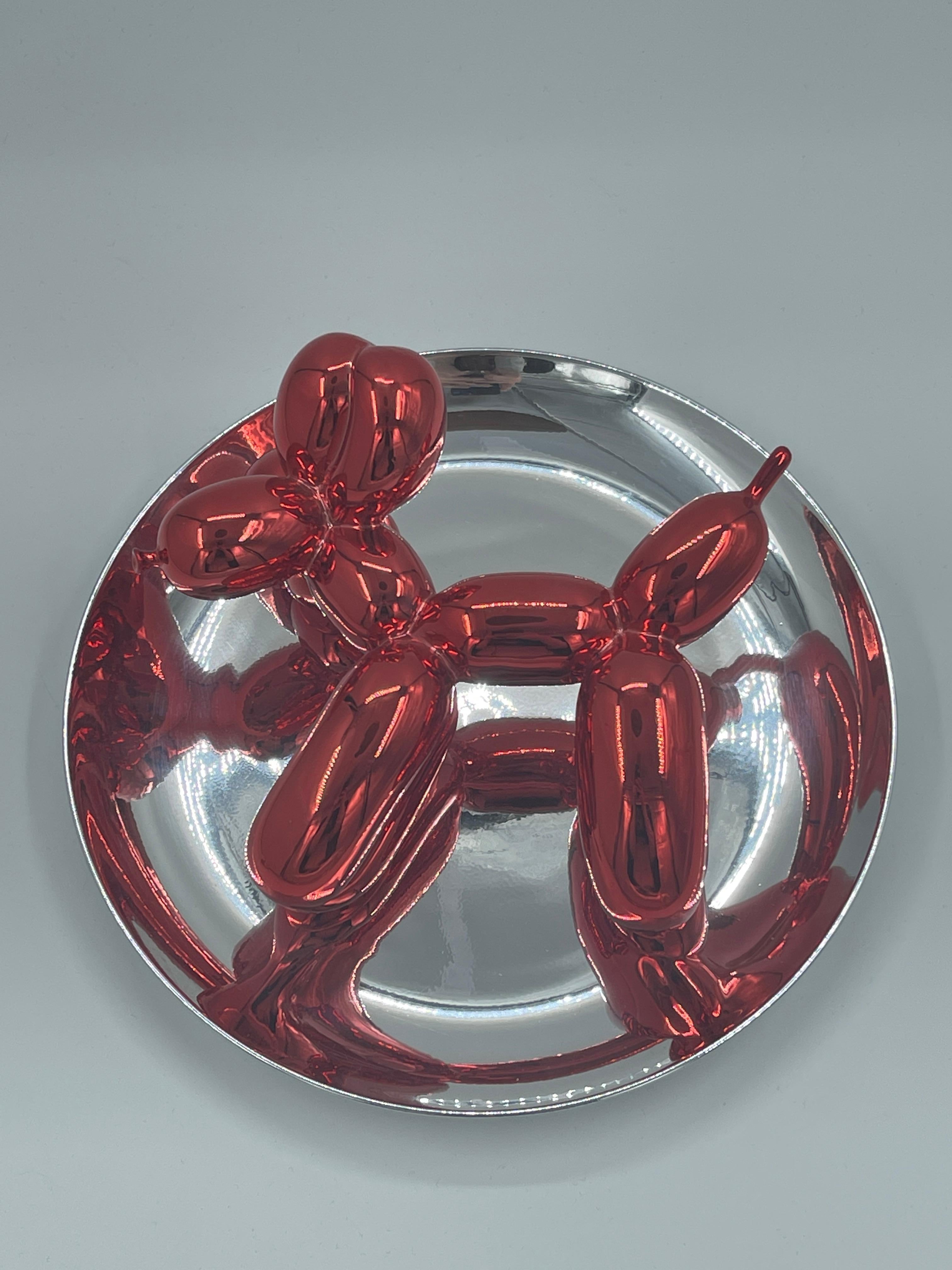 Plato de porcelana metálica en rojo y plata, fabricado en 1995, numerado 723/2300 en la etiqueta situada debajo del plato. Publicado por el Museo de Arte Contemporáneo de Los Ángeles, con caja original y sin el soporte de plástico. 