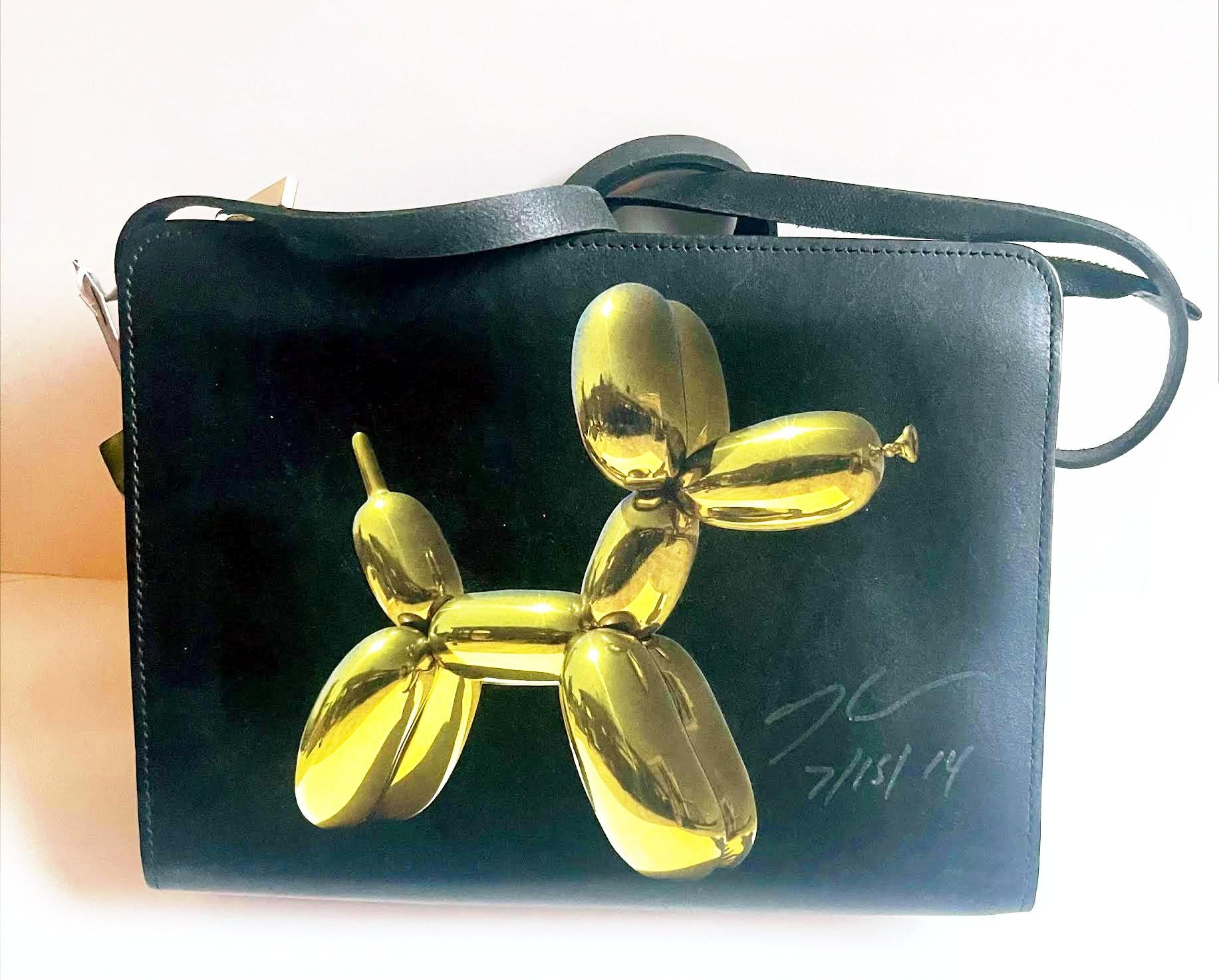 Jeff Koons
Balloon Dog Women
s Shoulder Bag (Hand Signed by Jeff Koons), 2014
100% Leather Shoulder Bag with silkscreened image of yellow balloon dog. 
Hand signed and dated by Jeff Koons.
9 × 9 1/2 × 2 3/4 inches
This leather women
s shoulder bag