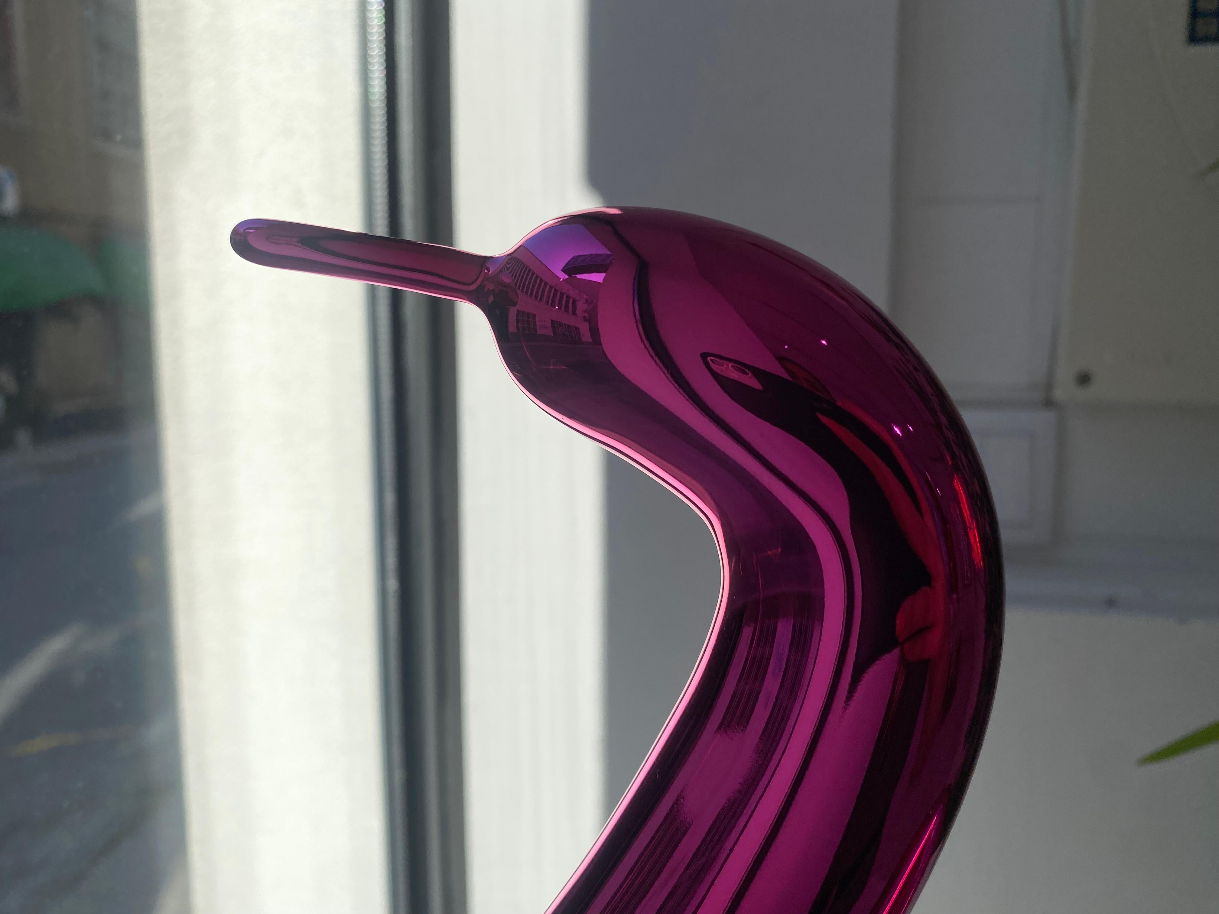 Limited Edition of 999.

Jeff Koons transforms a simple twisted balloon swan into a reflective magenta porcelain for his limited edition, Balloon Swan (Magenta). The original Balloon Swan, 2004–2011, is a monumental sculpture, standing over 3 meters