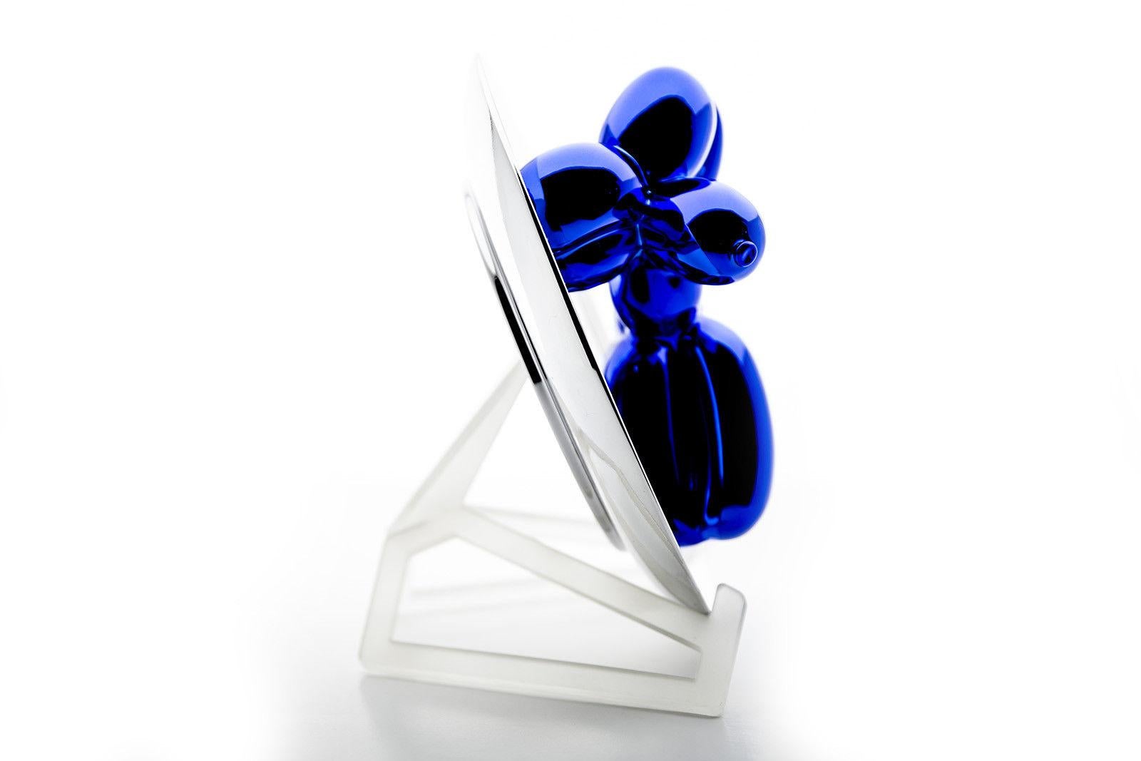 Artist: Jeff Koons 
Title: Balloon Dog (Blue) 
Medium: porcelain 
Size: 10 1/2 x 10 1/2 x 5 inches 
Edition of 2300 plus 50 APs 2002 
Condition of this particular blue dog is museum grade quality.   
Includes: Dog, box, stand as if purchased new. 