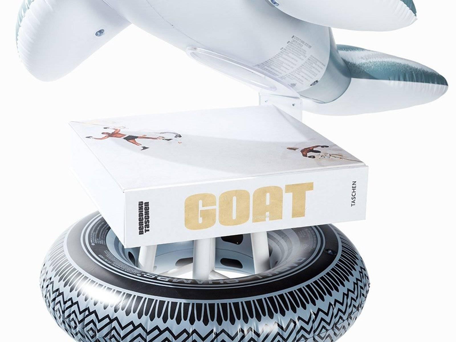 Jeff Koons (American, born 1955)
GOAT: A Tribute to Muhammad Ali (Champ’s Edition), 2004
Sculpture installation: Titled “Radial Champs” and consisting of a blow-up dolphin, a tire sculpture, and stool (175 x 170 cm)
Book: Hardcover Book in Clamshell