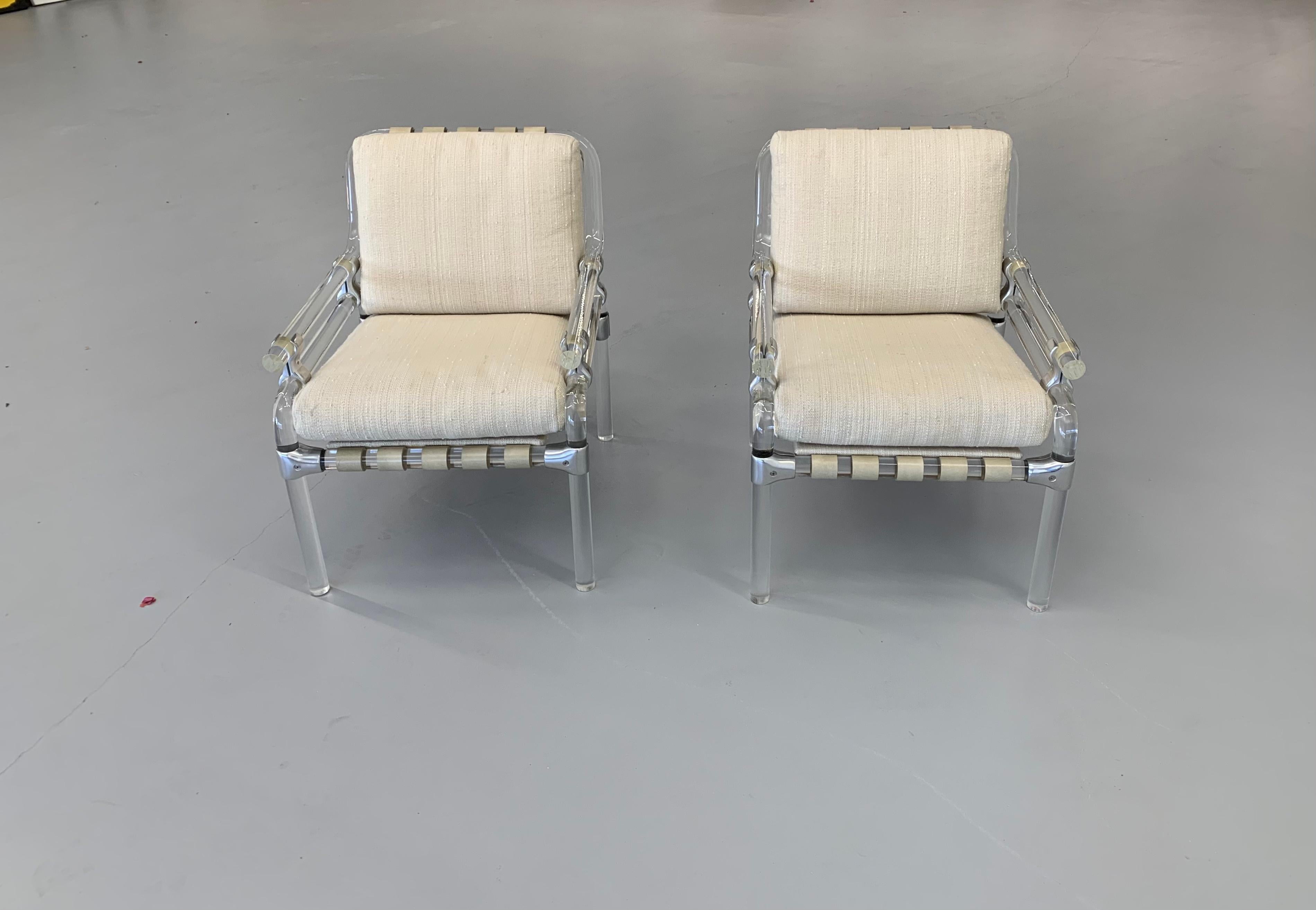 A nice pair of lucite and metal chairs by Jeff Messerschmidt. They are Pipeline 1000 chairs and numbered 37 and 38, 1973. The leather straps are original and the cushions are of recent vintage and in good condition. Great overall condition for