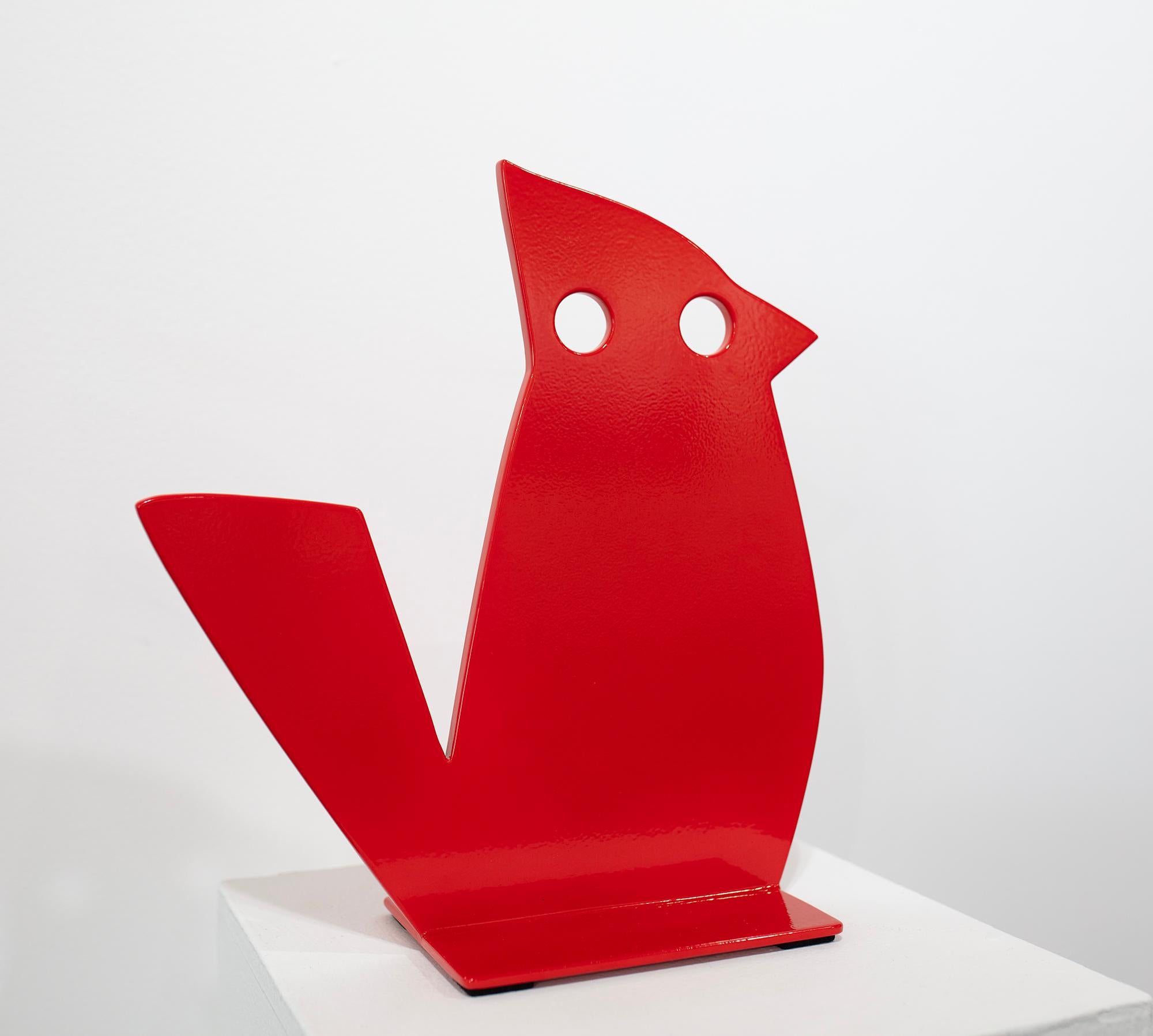 This free-standing sculpture of a vibrant red abstracted cardinal bird by Jeffie Brewer is made with powder coated steal. Two cut-out circular eyes are situated on the bird's face, with a tail that extends outward from the abstract form. White