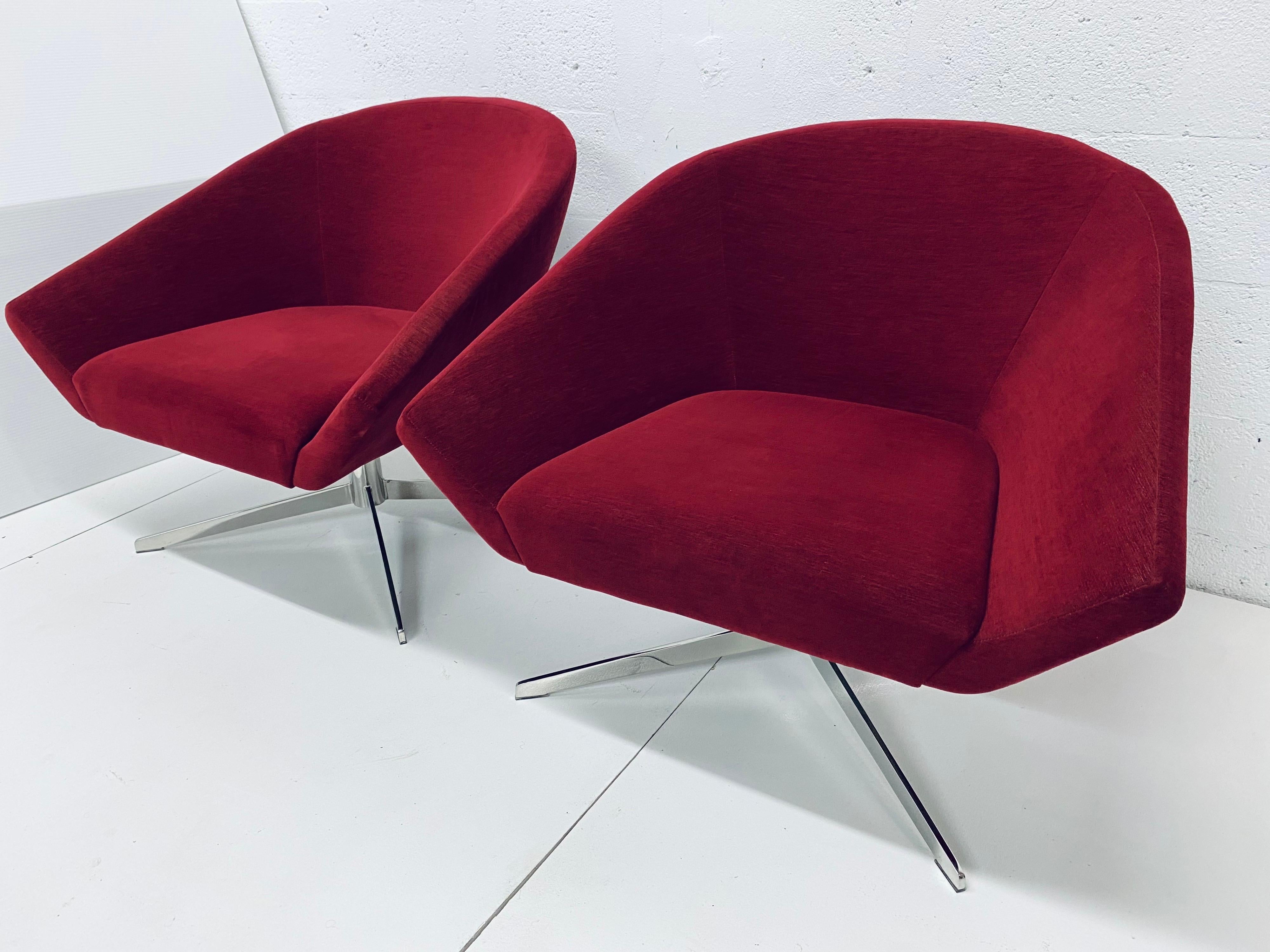 Pair of Jeffrey Bernett designed swivel lounge chairs with red cotton blend fabric seats on self returning chrome bases. Manufactured by Bernhardt USA.