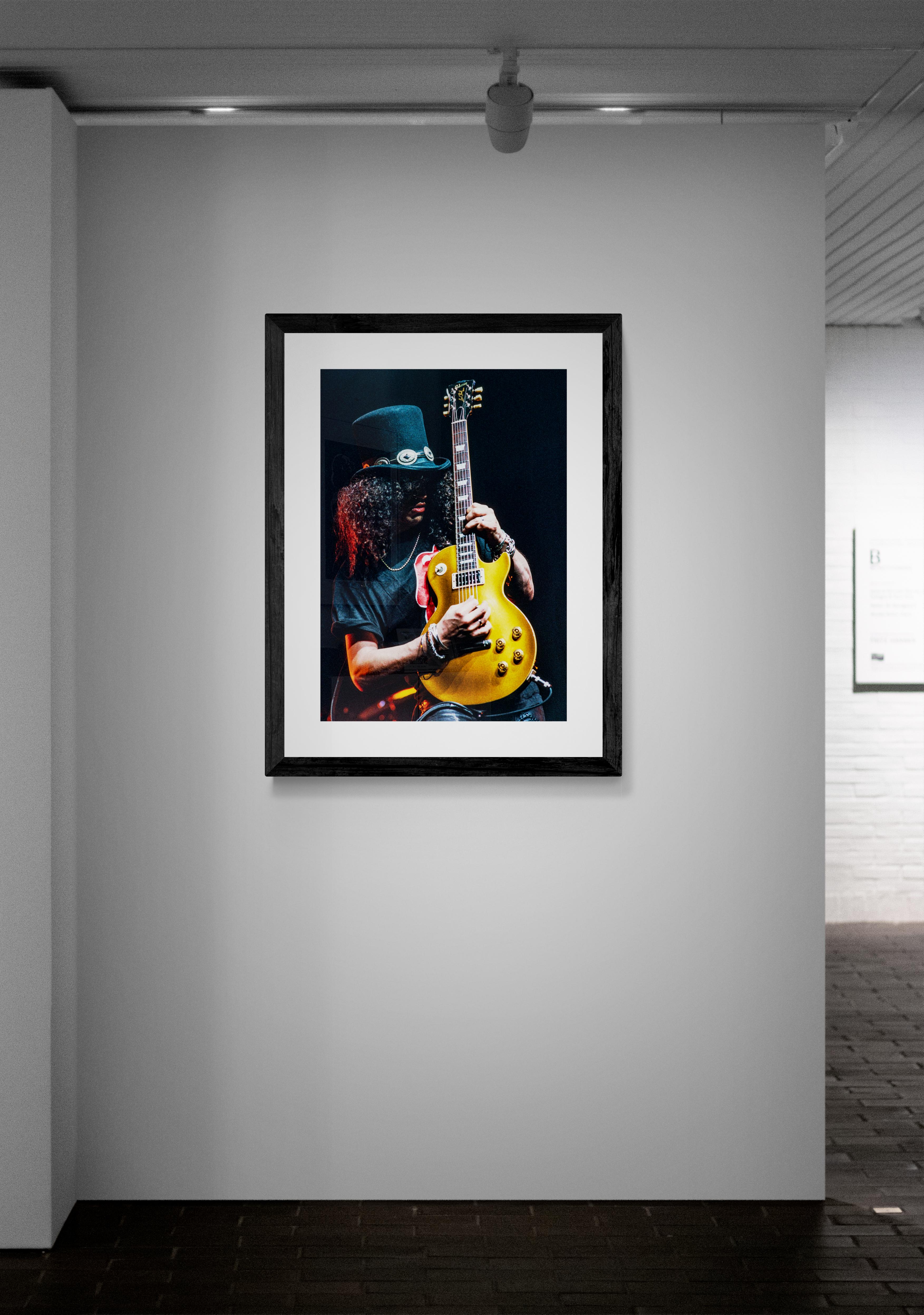 Iconic image of Guns N' Roses guitarist Slash shot in 1993 at the LA Sports Arena during a guest appearance at a Billy Joel Concert.

Artist: Jeffrey Mayer

Limited Edition: Signed and hand numbered in the margin, archival pigment print on 100%