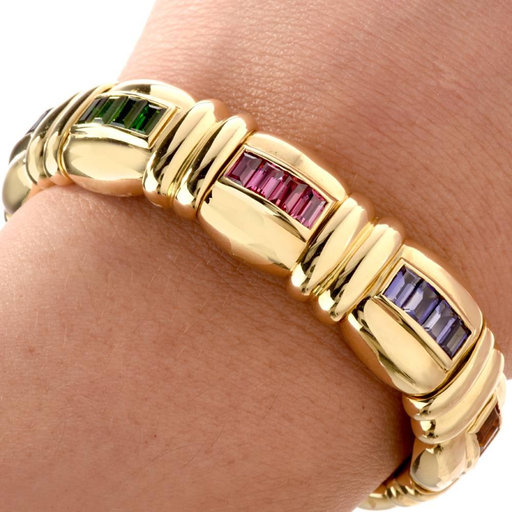 This elegant bangle bracelet from designer Jeffrey Stevens rainbow collection is crafted in 18K Yellow Gold. Showcasing a link design, this stylish bangle bracelet is adorned with 4 genuine baguette cut Amethysts, 4 genuine baguette cut Green