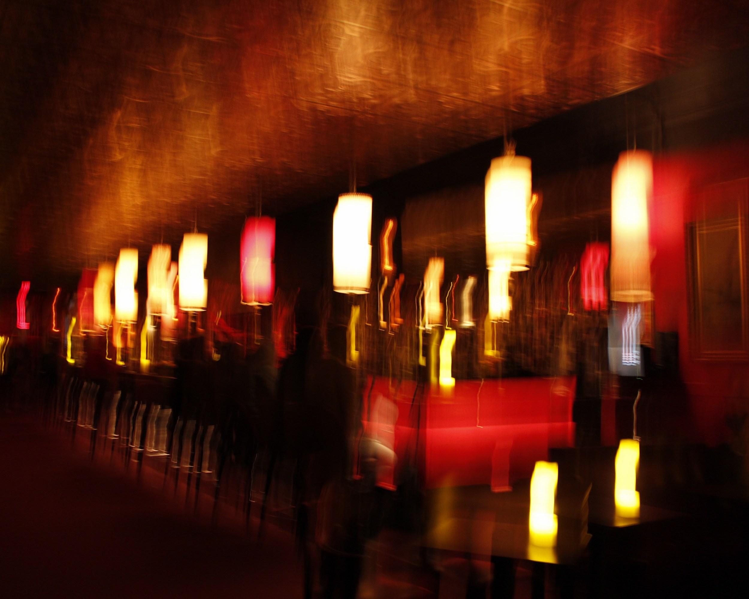 Jeffrey Tamblyn Abstract Photograph - Rhythm Bar (nightlife, retro decor, bright colors, motion blur, bar)