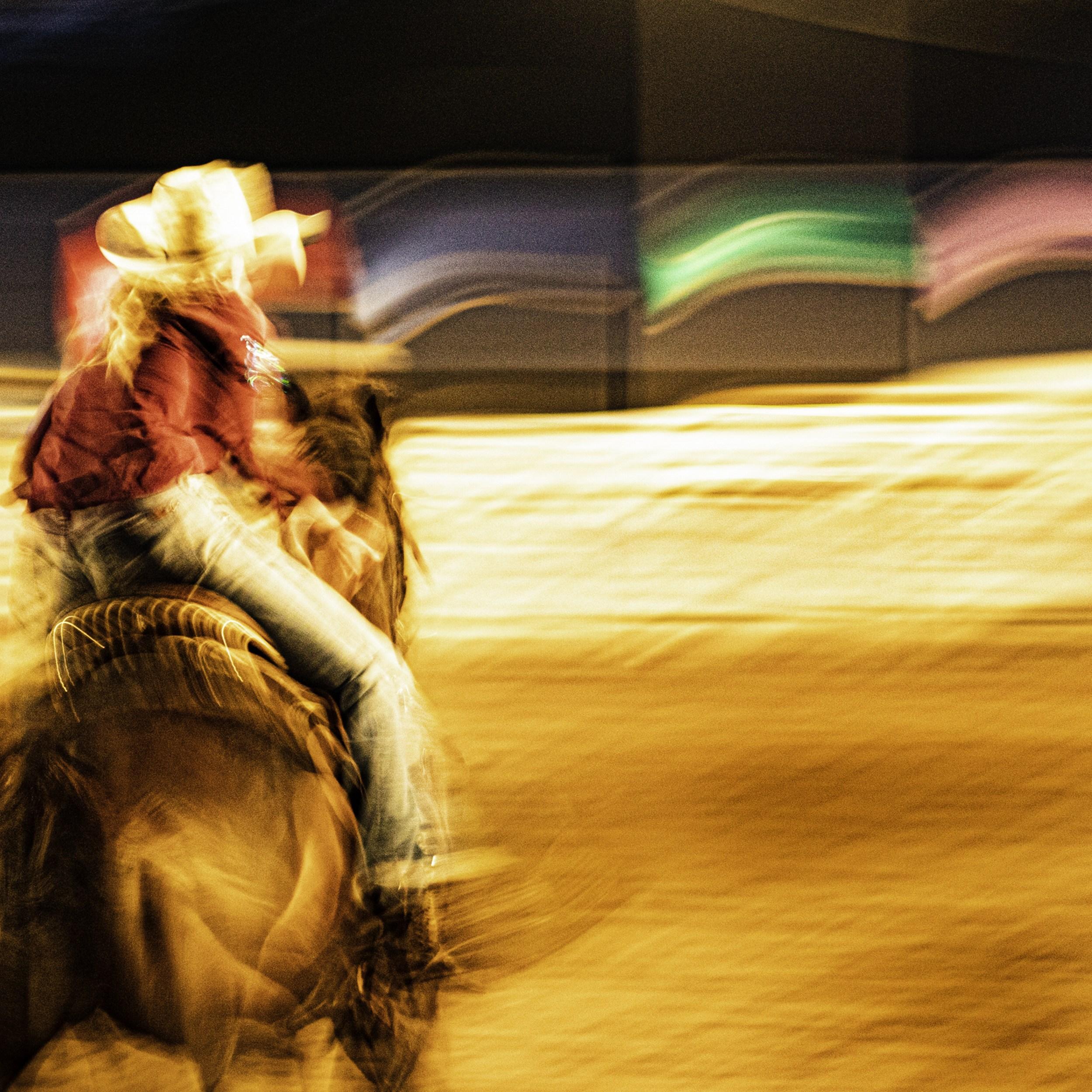Jeffrey Tamblyn Figurative Photograph - Wide Awake (rodeo, horse, barrel race, colorful, motion blur)