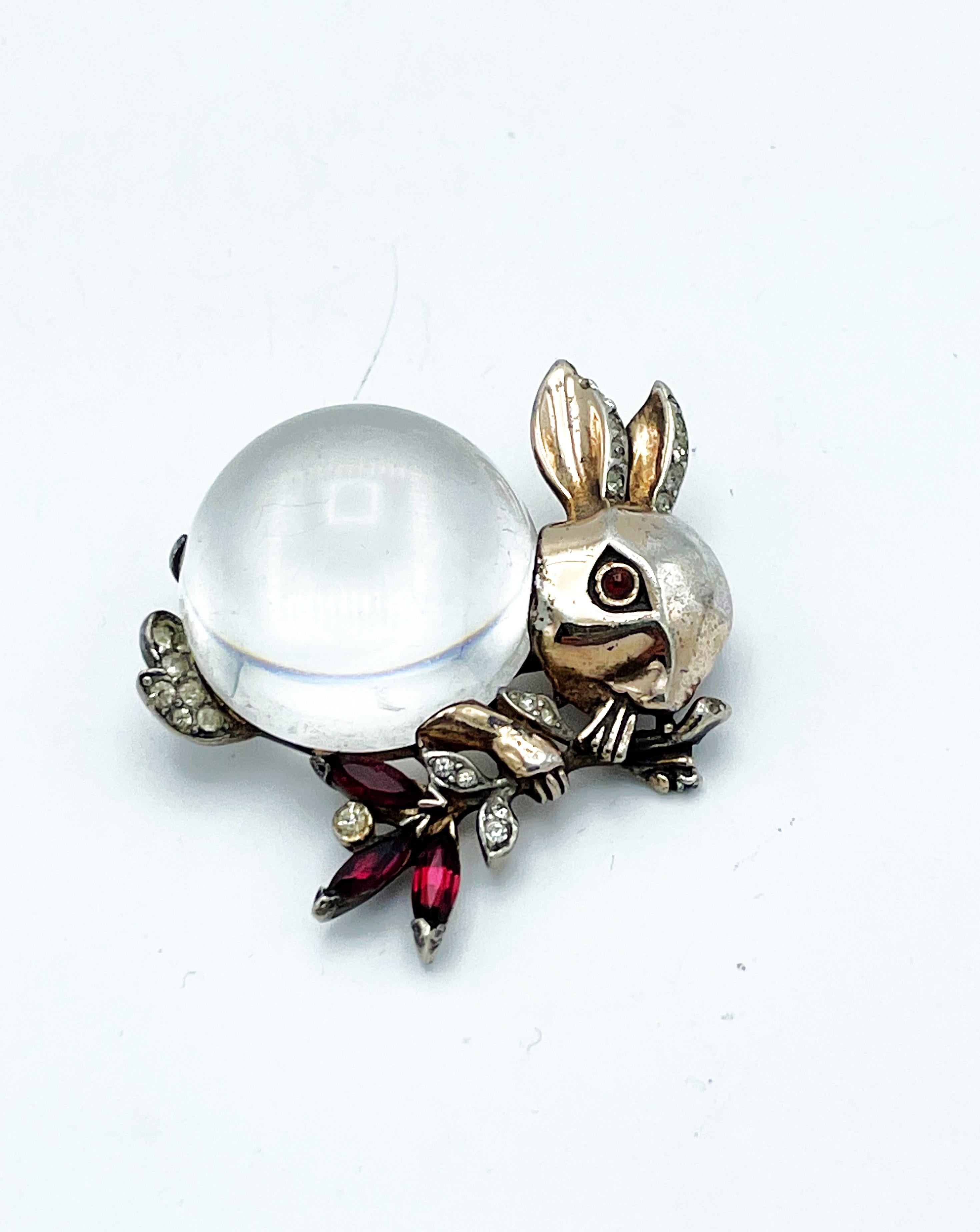 Jelly Belly Rabbit brooch by Trifari USA made by Sterling silber gold plated. 
In the 1940s, no rhinestones could be imported into the USA from Europe.
Necessity is the mother of invention and a whole series of animals with a body made of thick