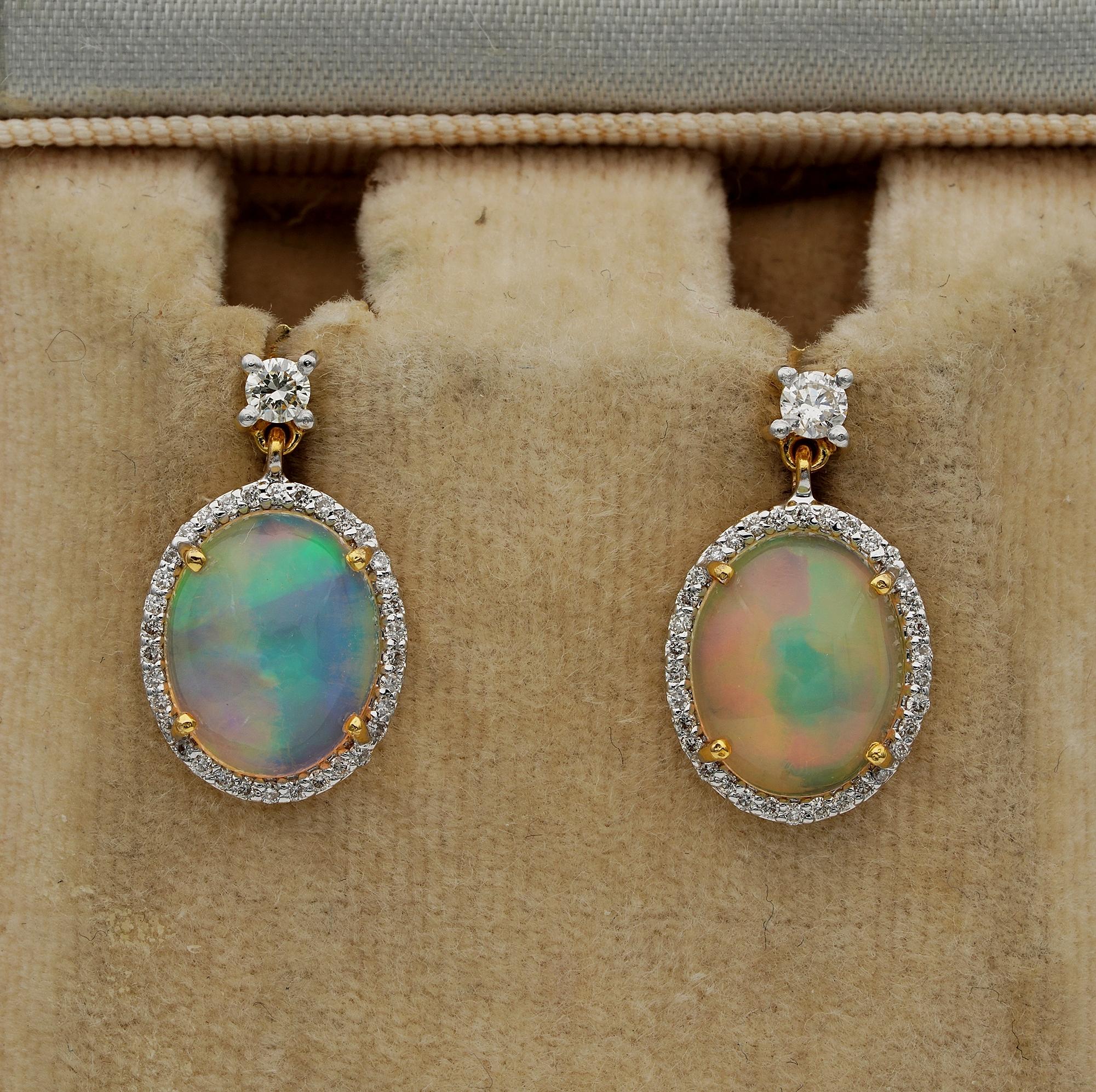 Magic Rainbow Dropping from Ears
Mesmerizing Opals are the star of these ear drops
Designed as swinging oval drops with two Opals surrounded by a halo of Diamonds topped by a small solitaire – hand crafted of solid 18 KT gold
Two deep cut natural