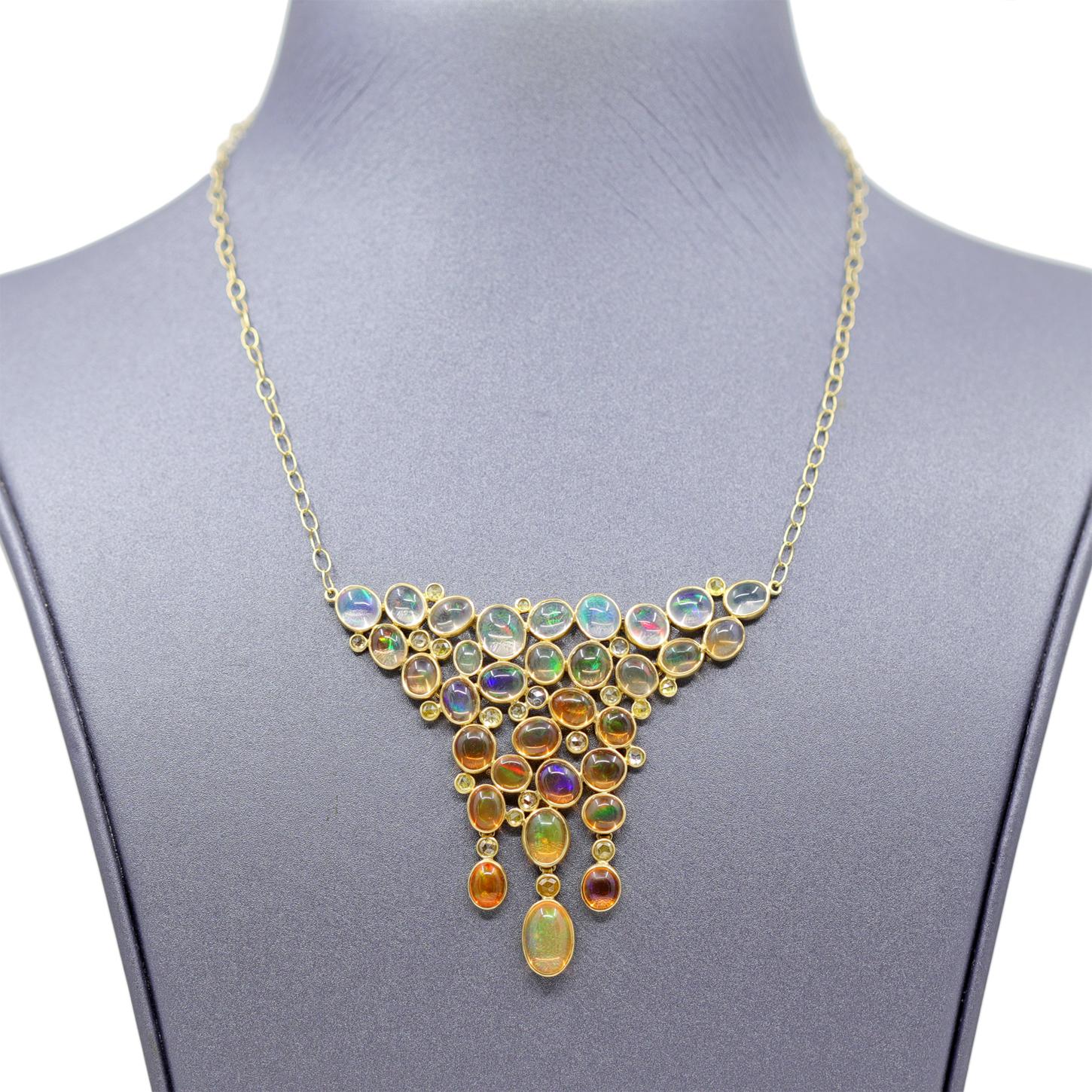 A  one-of-one wearable work of art, this intricate handmade necklace by jewelry designer Tej Kothari showcases an otherworldly assortment of translucent white Mexican jelly opal and orange Mexican fire opal oval cabochons meticulously arranged in an