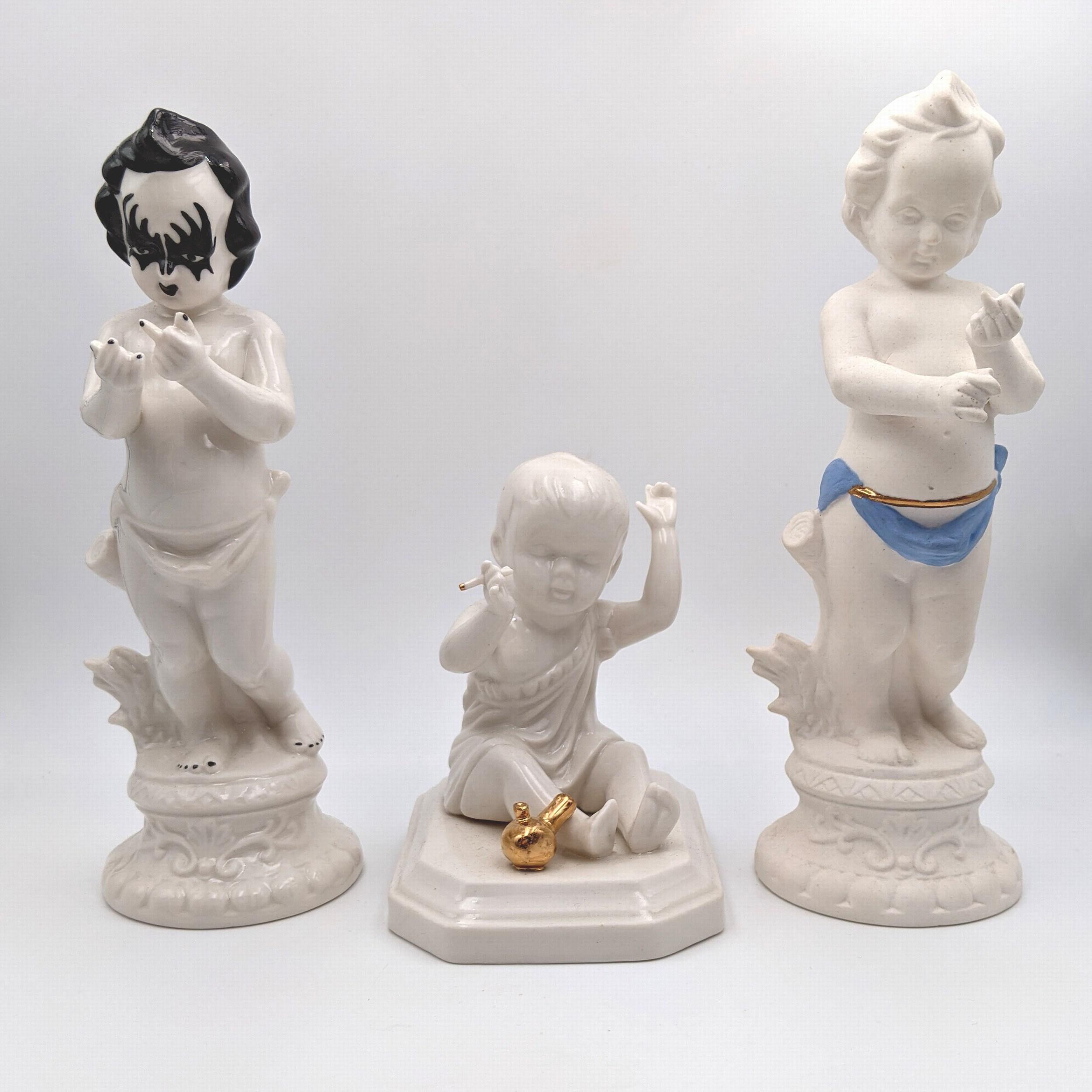 Jen Watson
Rude Cherub (KISS Paint)
Year: 2021
Medium: Porcelain, Glaze, Luster 
Size: 8 x 2.25 x 3.5 inches
Signed
COA included

About Jen Watson:

My figurines exist somewhere between relic and homage, honoring the tradition of the figurine and